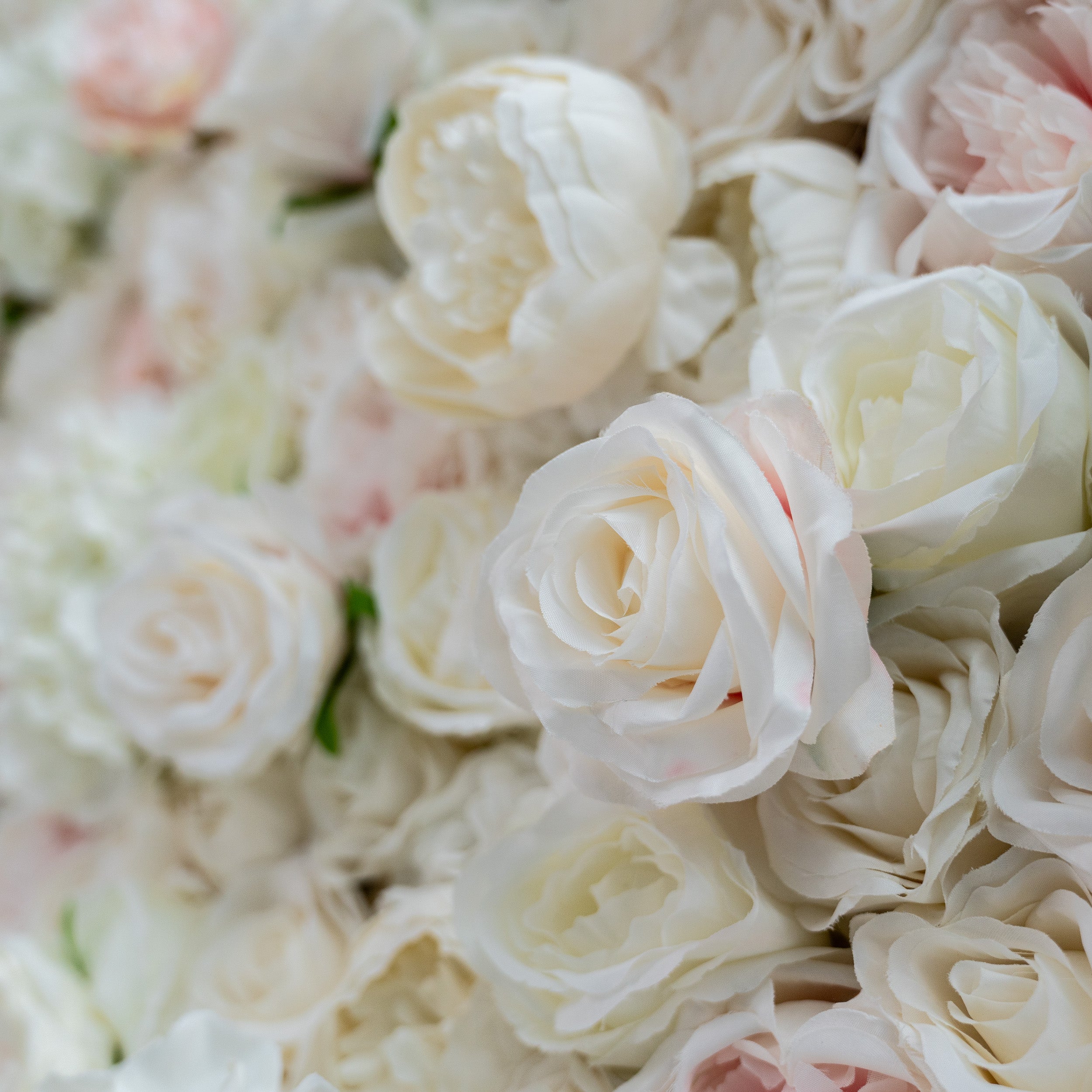 This close - up image highlights the texture of the flowers. The petals appear soft and slightly ruffled, with a realistic sheen that mimics fresh flowers. The materials used seem to be high - quality artificial flowers, likely made from silk or a similar fabric, giving them a luxurious and lifelike appearance.