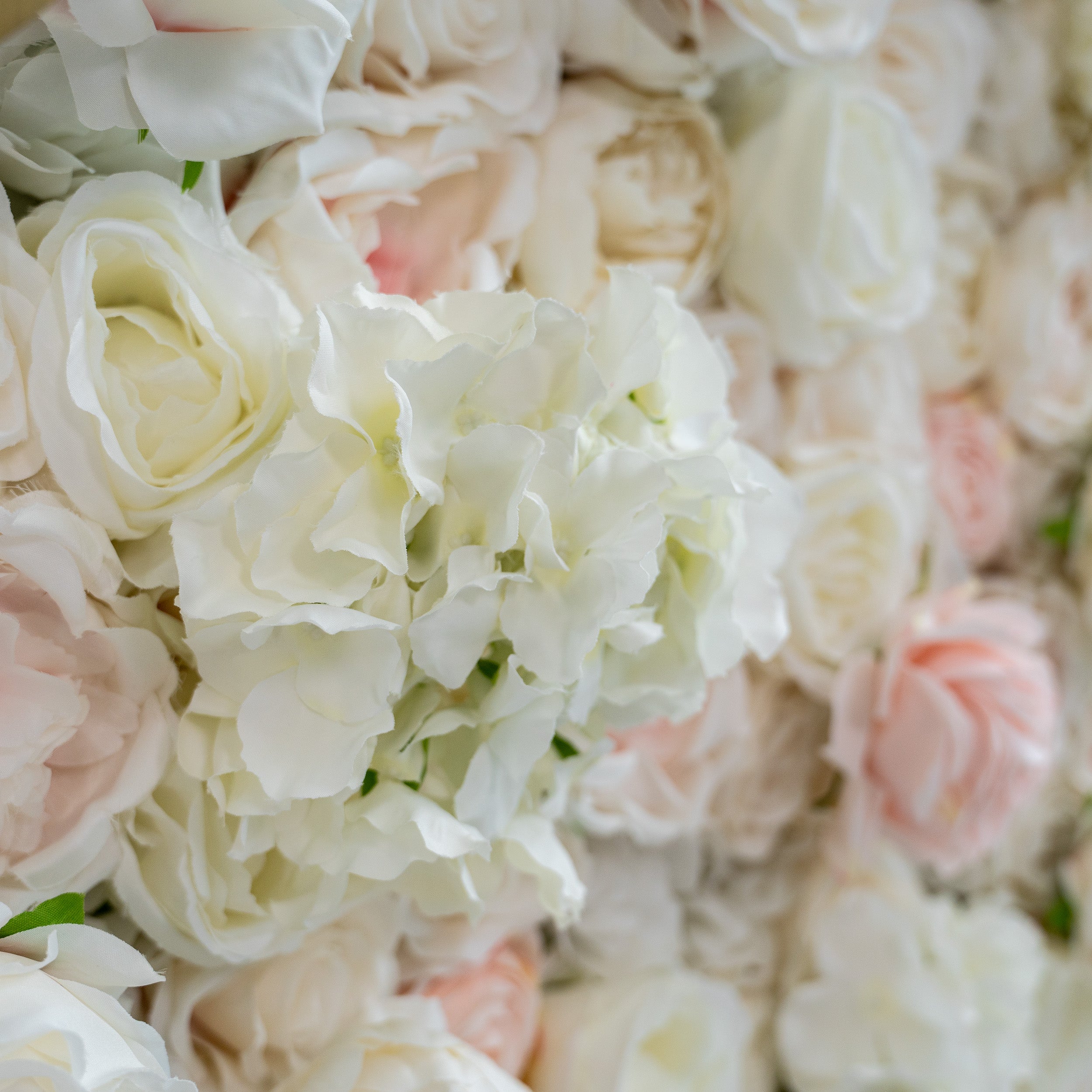 This close - up image highlights the texture of the flowers. The petals appear soft and slightly ruffled, with a realistic sheen that mimics fresh flowers. The materials used seem to be high - quality artificial flowers, likely made from silk or a similar fabric, giving them a luxurious and lifelike appearance.
