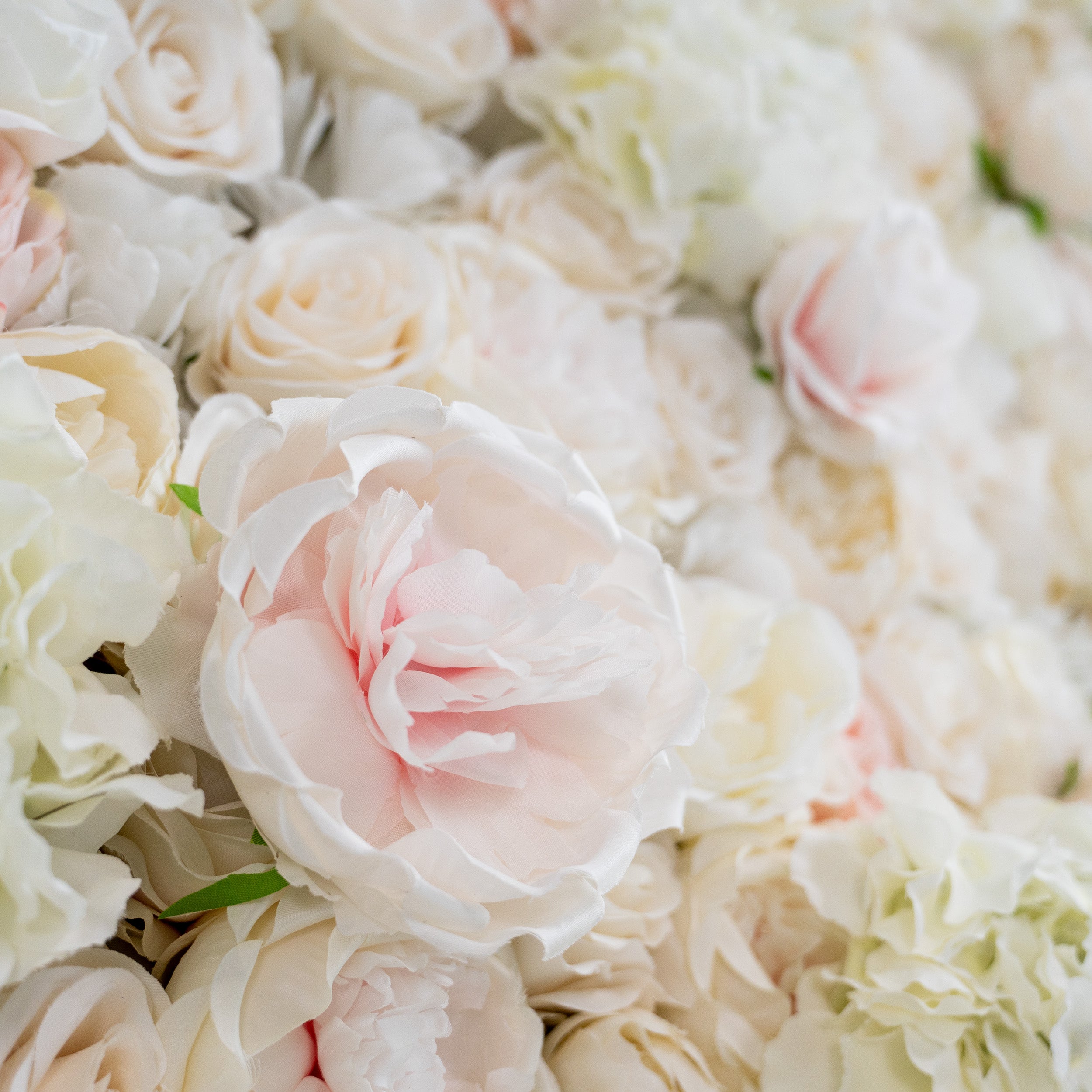 This close - up image highlights the texture of the flowers. The petals appear soft and slightly ruffled, with a realistic sheen that mimics fresh flowers. The materials used seem to be high - quality artificial flowers, likely made from silk or a similar fabric, giving them a luxurious and lifelike appearance.