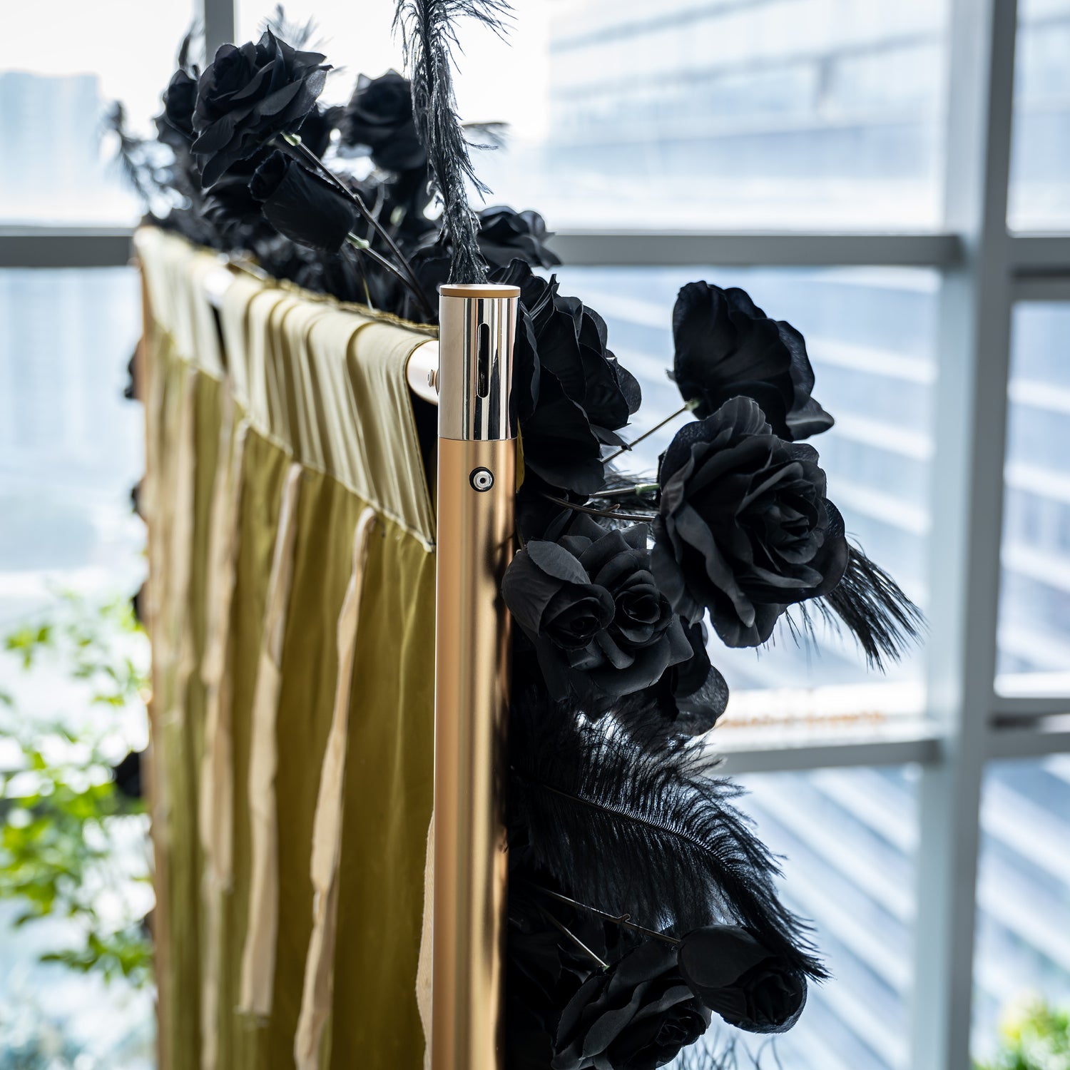 The image shows a section of a luxurious black rose wall with the brand name "ValarFlowers" prominently displayed. The wall is adorned with feathers at the edges, creating a dramatic and elegant look.