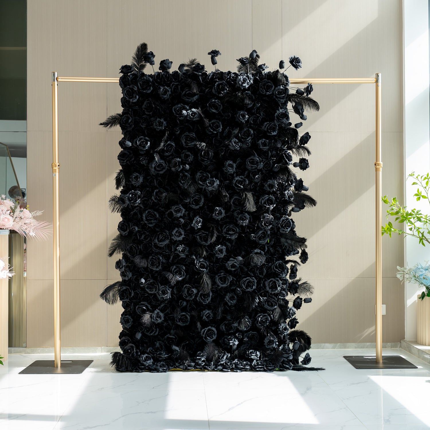 This is a 4x8ft (1.2x2.4m) version of the black rose wall. It features a dense arrangement of black roses with interspersed feathers, creating a dramatic and luxurious backdrop. The structure is framed by two golden poles, adding a touch of elegance. This size makes it suitable for large events such as weddings, galas, or corporate functions.
