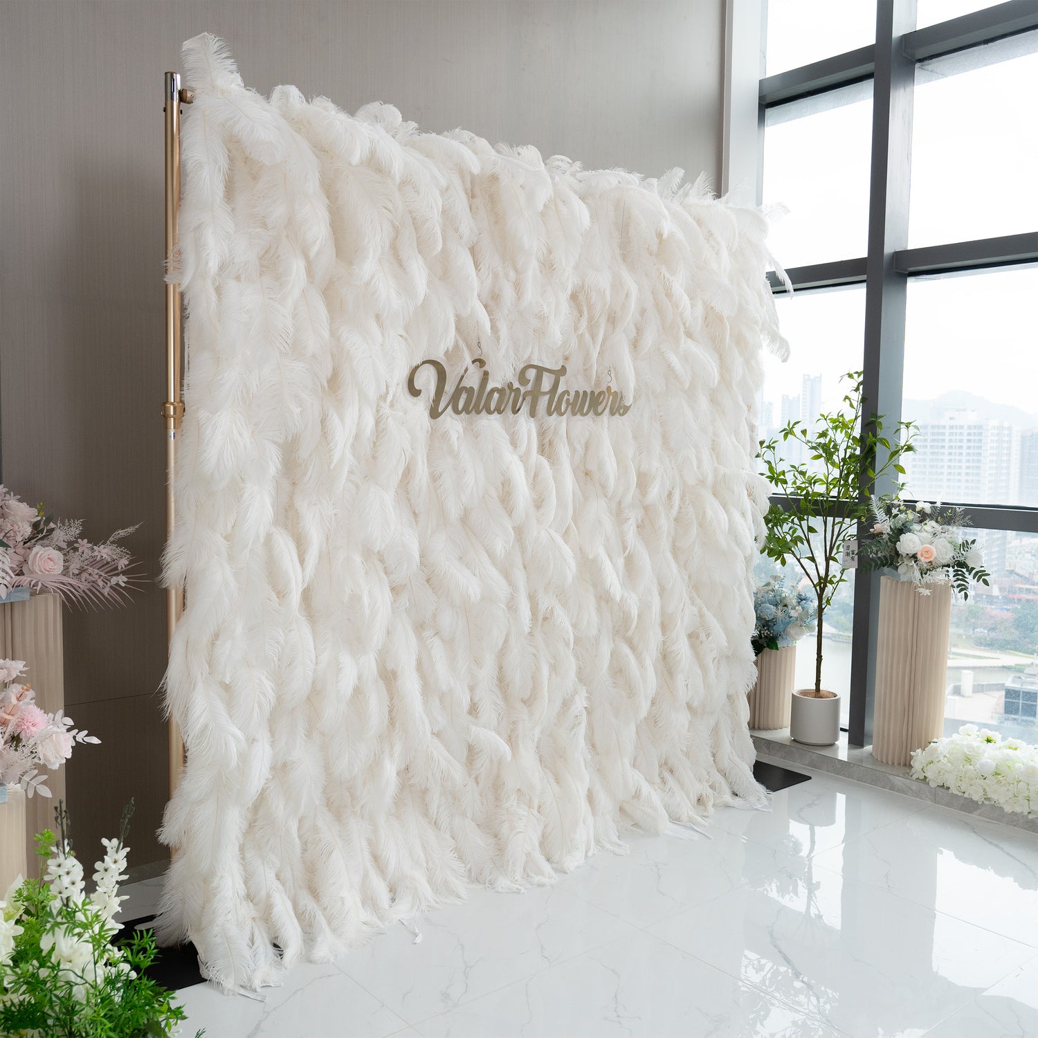 The ValarFlowers artificial feather wall is predominantly white, made of soft feathers. It has a luxurious and fluffy appearance, creating an elegant and dreamy atmosphere.