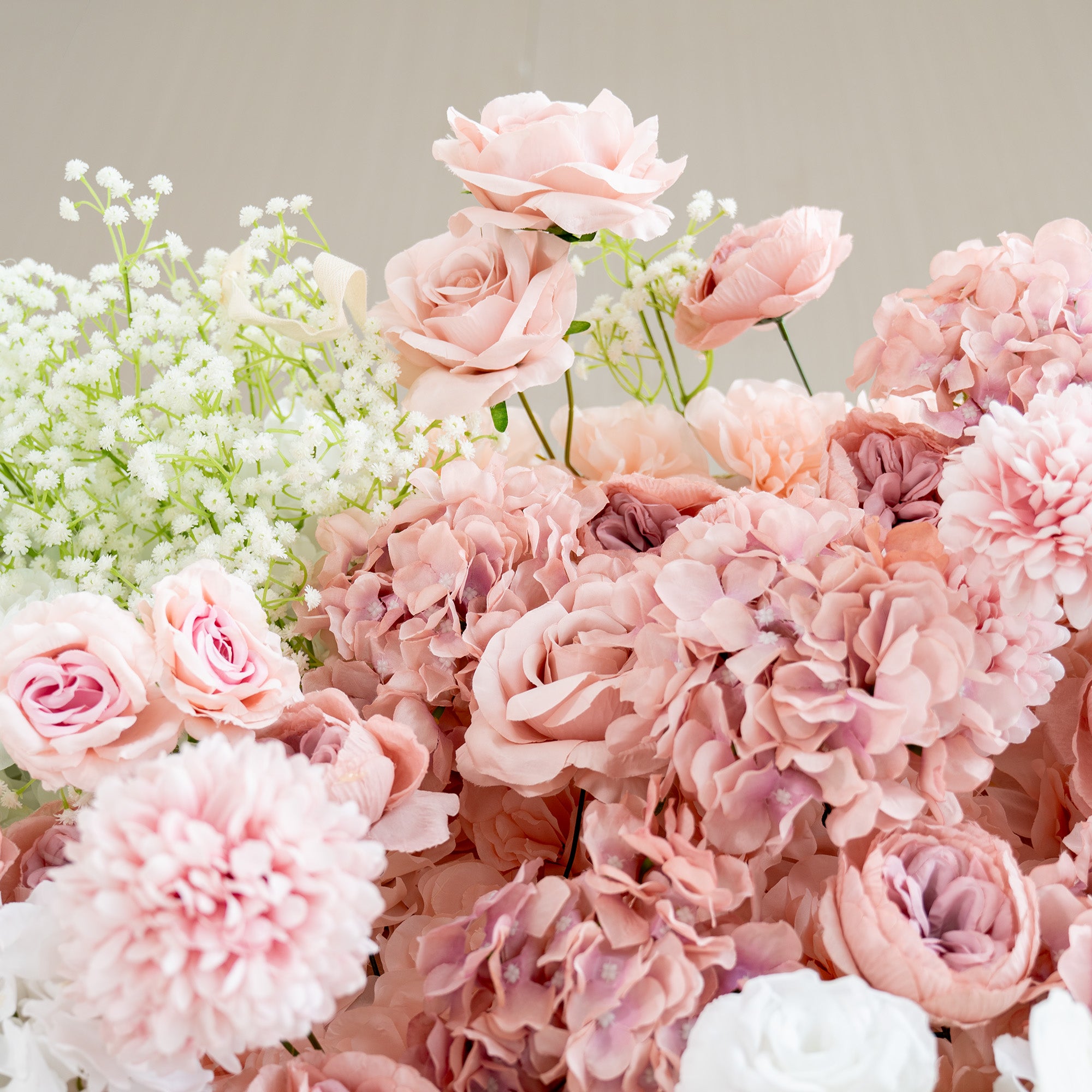 This backdrop features a rich arrangement of artificial flowers. The main flowers include delicate pink roses, white roses, and clusters of baby&