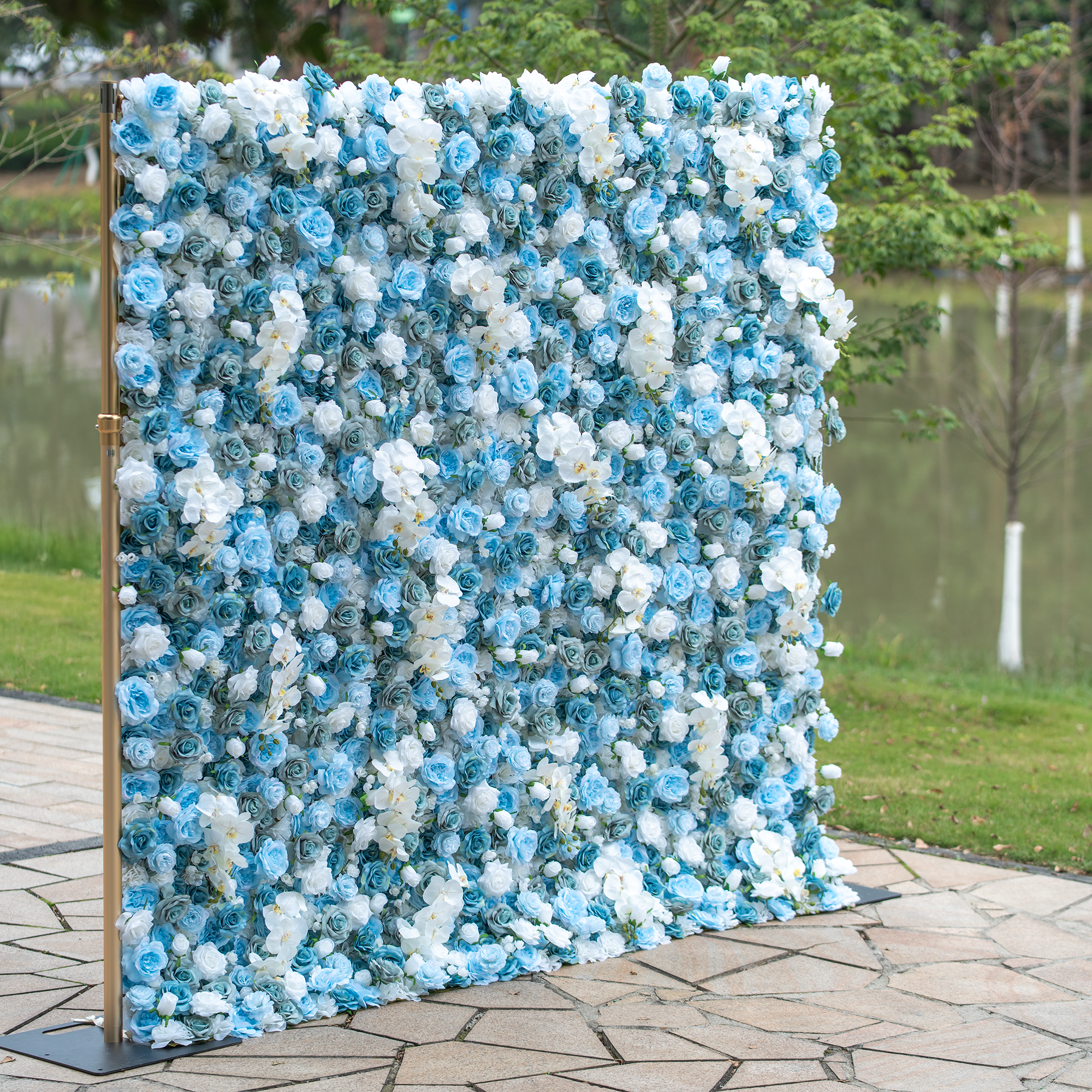 This backdrop features a lush arrangement of blue and white roses, creating a visually stunning display. The cool - toned flowers evoke a sense of tranquility and elegance. Ideal for weddings, engagement parties, or upscale corporate events, it aligns perfectly with themes of sophistication and modern romance. Set outdoors by a water body, it adds a natural and dreamy touch to the event space.