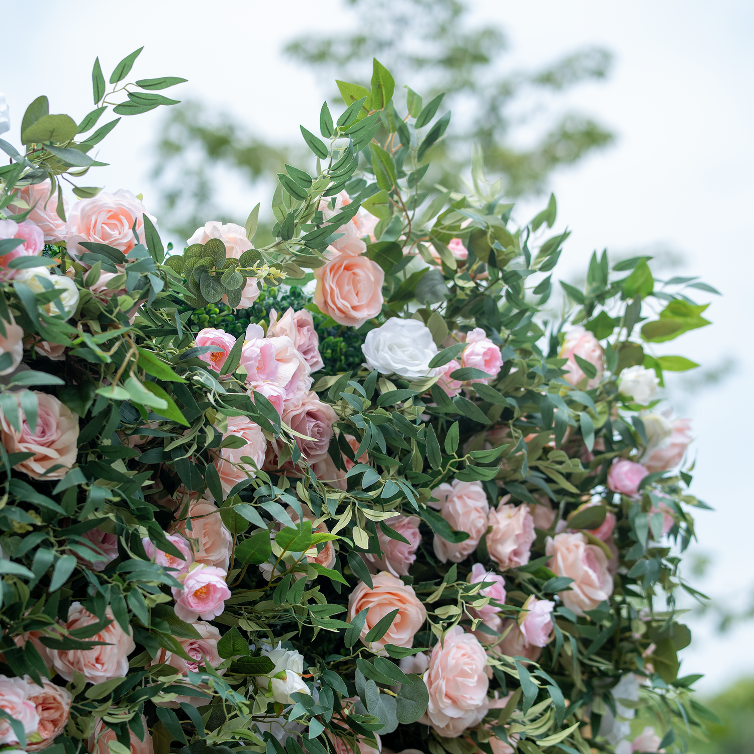 This photo showcases a lush arrangement of pink and white roses nestled among green foliage. The soft hues of the roses create a delicate and romantic ambiance. Ideal for events like engagement parties or Mother&