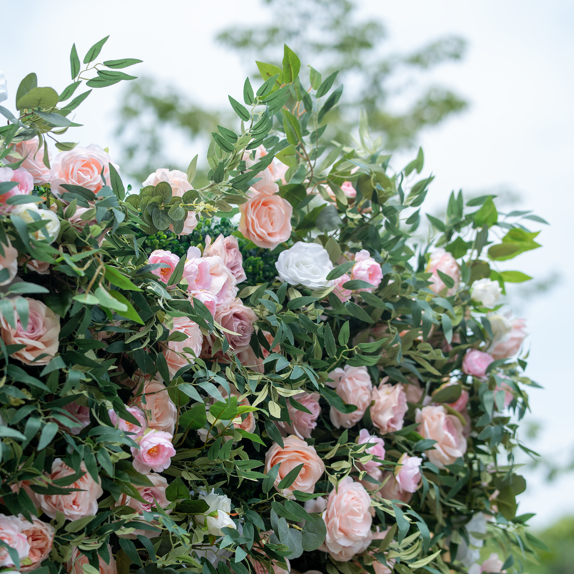 This photo showcases a lush arrangement of pink and white roses nestled among green foliage. The soft hues of the roses create a delicate and romantic ambiance. Ideal for events like engagement parties or Mother&