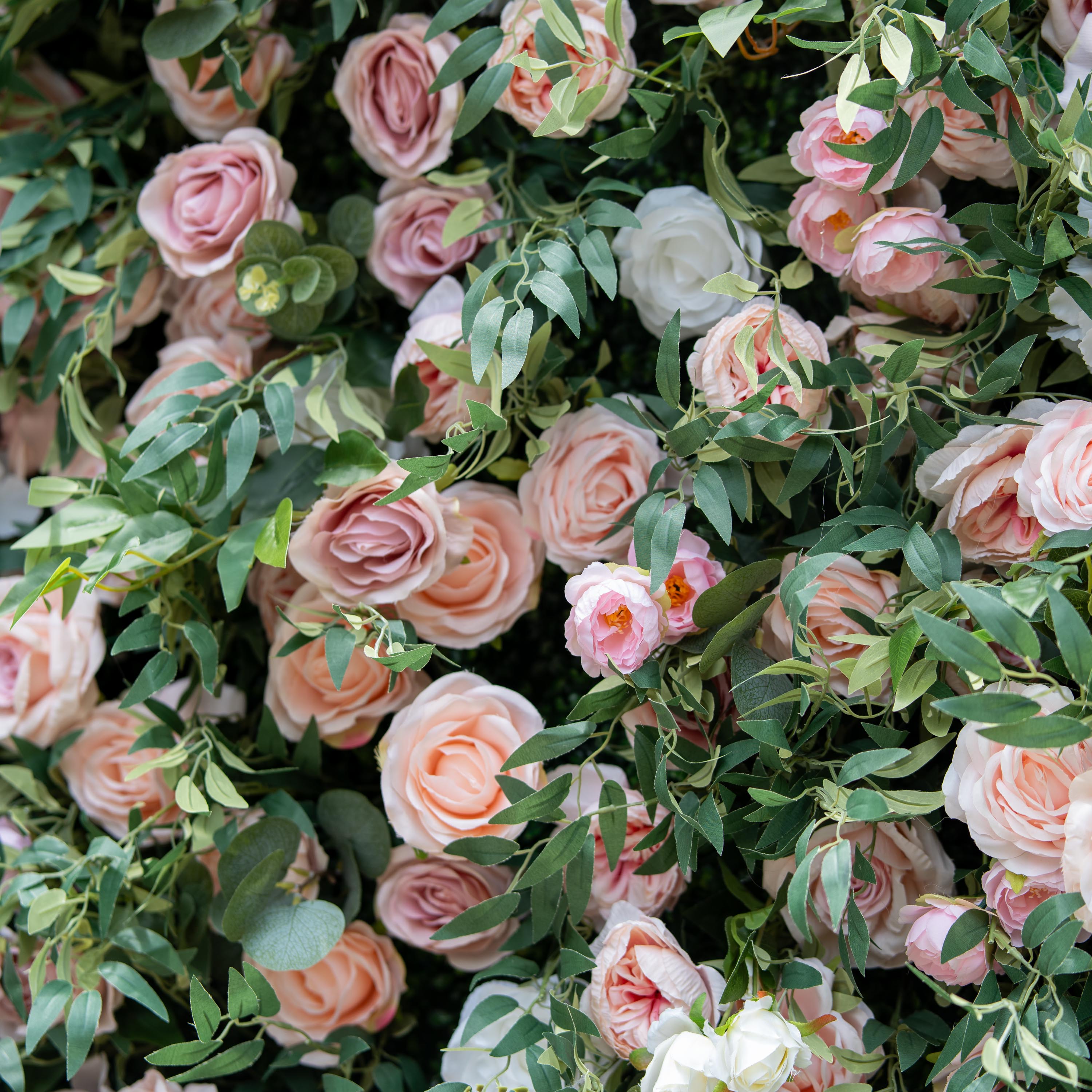 This photo showcases a lush arrangement of pink and white roses intertwined with green foliage. The soft hues and dense clustering create a romantic and elegant look. Ideal for events such as anniversary celebrations or spring - themed galas, it fits a "Blossoming Romance" theme. The natural beauty of the roses and greenery makes it a perfect decorative element for upscale, refined occasions.