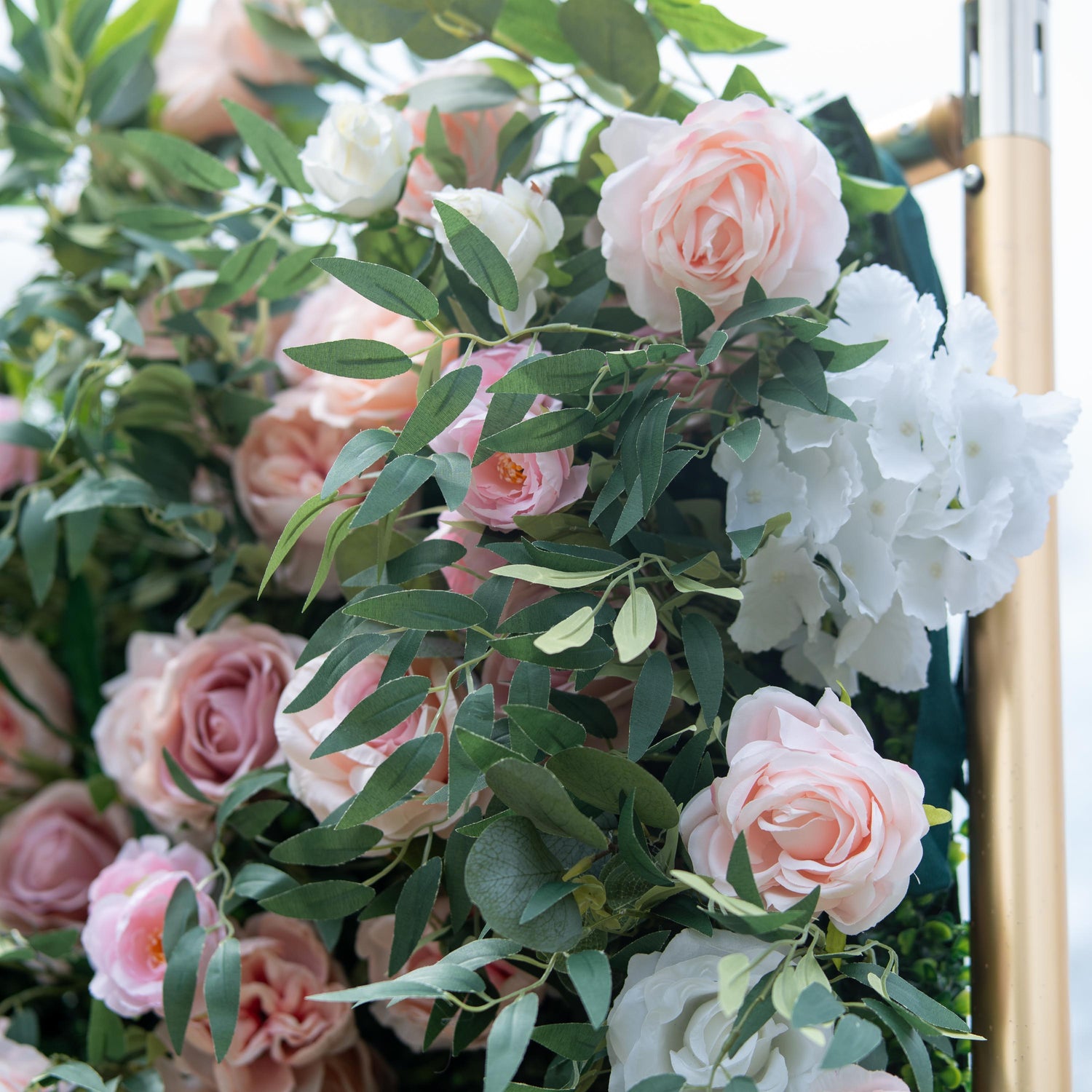 This photo features a lush arrangement of pink and white roses, along with white hydrangeas, interspersed among green foliage. The soft, pastel - colored blooms create a romantic and elegant atmosphere. Ideal for events like anniversary dinners or a "Floral Elegance Gala", it combines the charm of roses with the fullness of hydrangeas, making it perfect for refined and celebratory occasions.