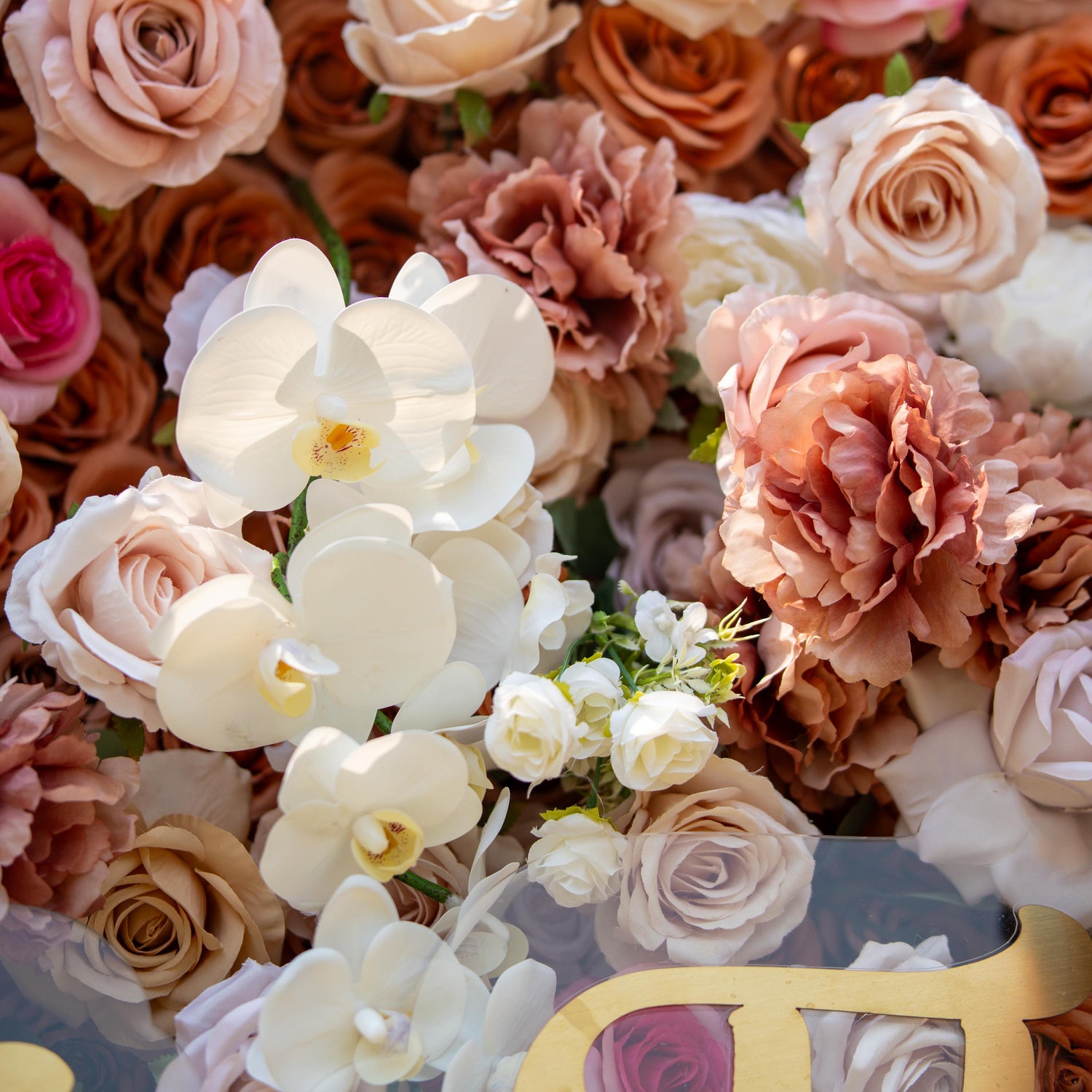 This backdrop features a warm, earthy theme with colors ranging from soft beige to rich brown. It showcases an arrangement of roses and white orchids. Ideal for elegant events like weddings, upscale garden parties, or sophisticated corporate functions.
