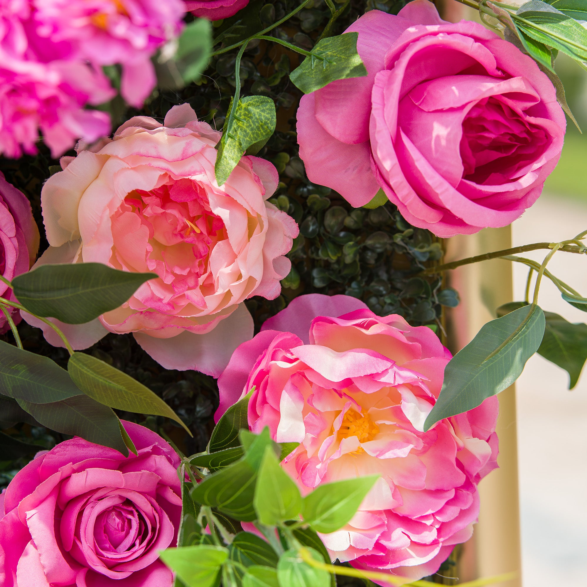 This photo showcases a lush arrangement of vibrant pink roses, interspersed with soft - hued pink and peach - toned blooms. The flowers are surrounded by rich green foliage, creating a visually striking contrast. The roses, with their full, layered petals, exude a sense of elegance and romance, making this arrangement perfect for events like weddings or celebratory garden parties.