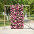 This photo showcases a 4X8ft floral backdrop mounted on a golden stand. It is densely covered with a vibrant mix of pink and white roses and other pink flowers, interspersed with lush green foliage. Set outdoors on a paved path with greenery in the background, it exudes a lively and romantic charm, ideal for events like weddings or garden parties.
