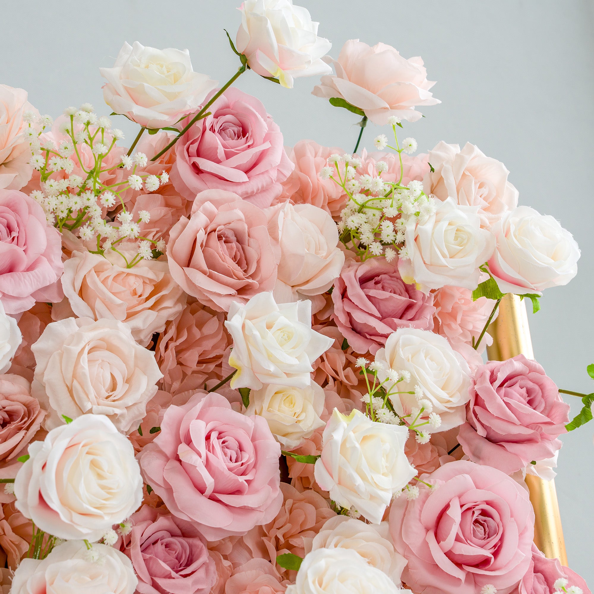 This photo brims with an assortment of roses in soft hues of pink, peach, and white, interspersed with delicate sprigs of baby&