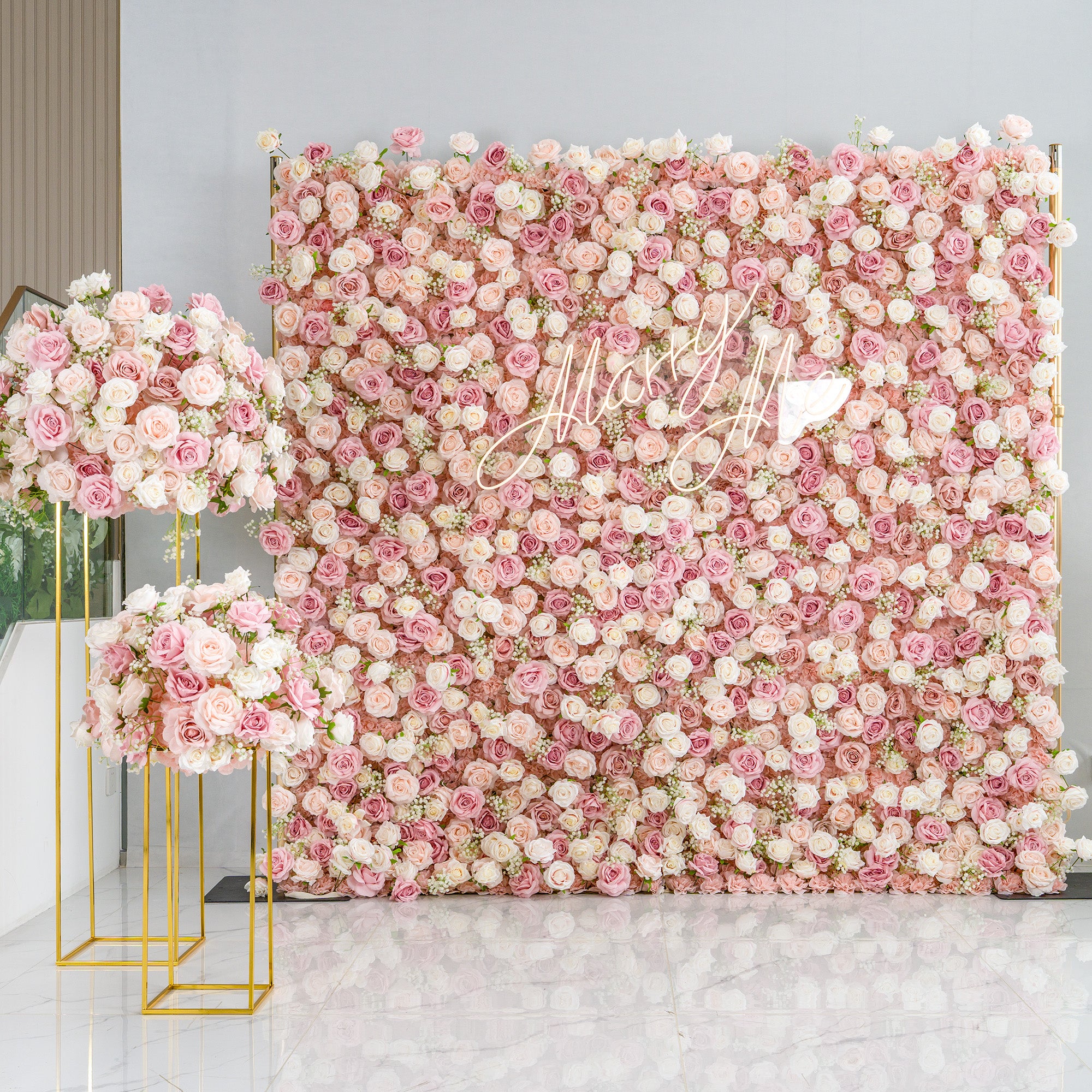 This photo showcases a stunning floral setup. A large backdrop is densely covered with pink and white roses, creating a dreamy and romantic atmosphere. The cursive text "Mary Me" adds a personalized touch. Flanking the backdrop are two golden - framed stands holding matching floral arrangements. Ideal for weddings or engagement parties, it exudes elegance and charm with its pastel color scheme.