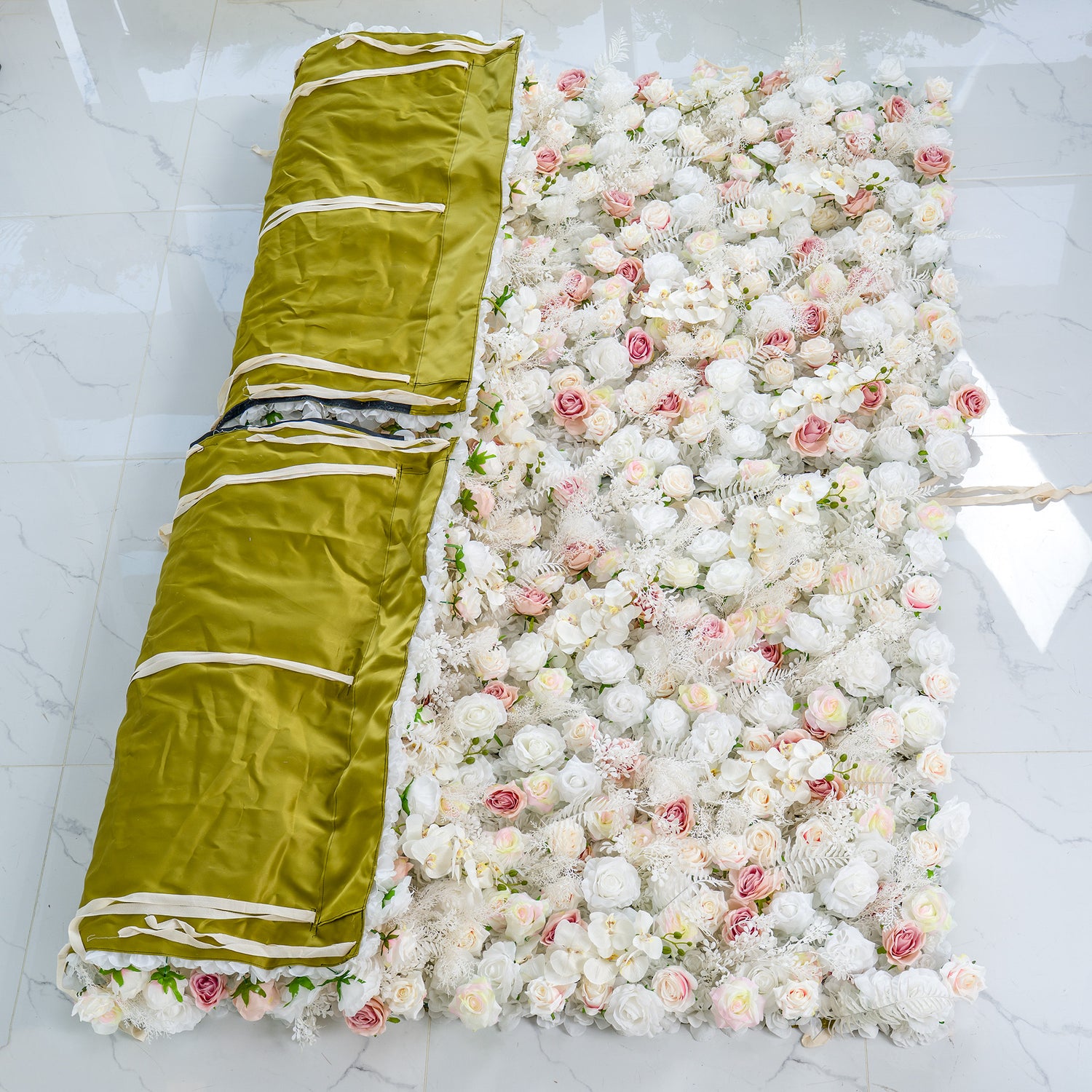 This photo shows the backings of two 4*8ft floral panels. The front side is densely decorated with white roses, pink roses, and white foliage, creating a soft color scheme of white and light pink. The back is covered with olive - green fabric with white straps. Ideal for weddings or upscale events, it exudes an elegant and dreamy style.