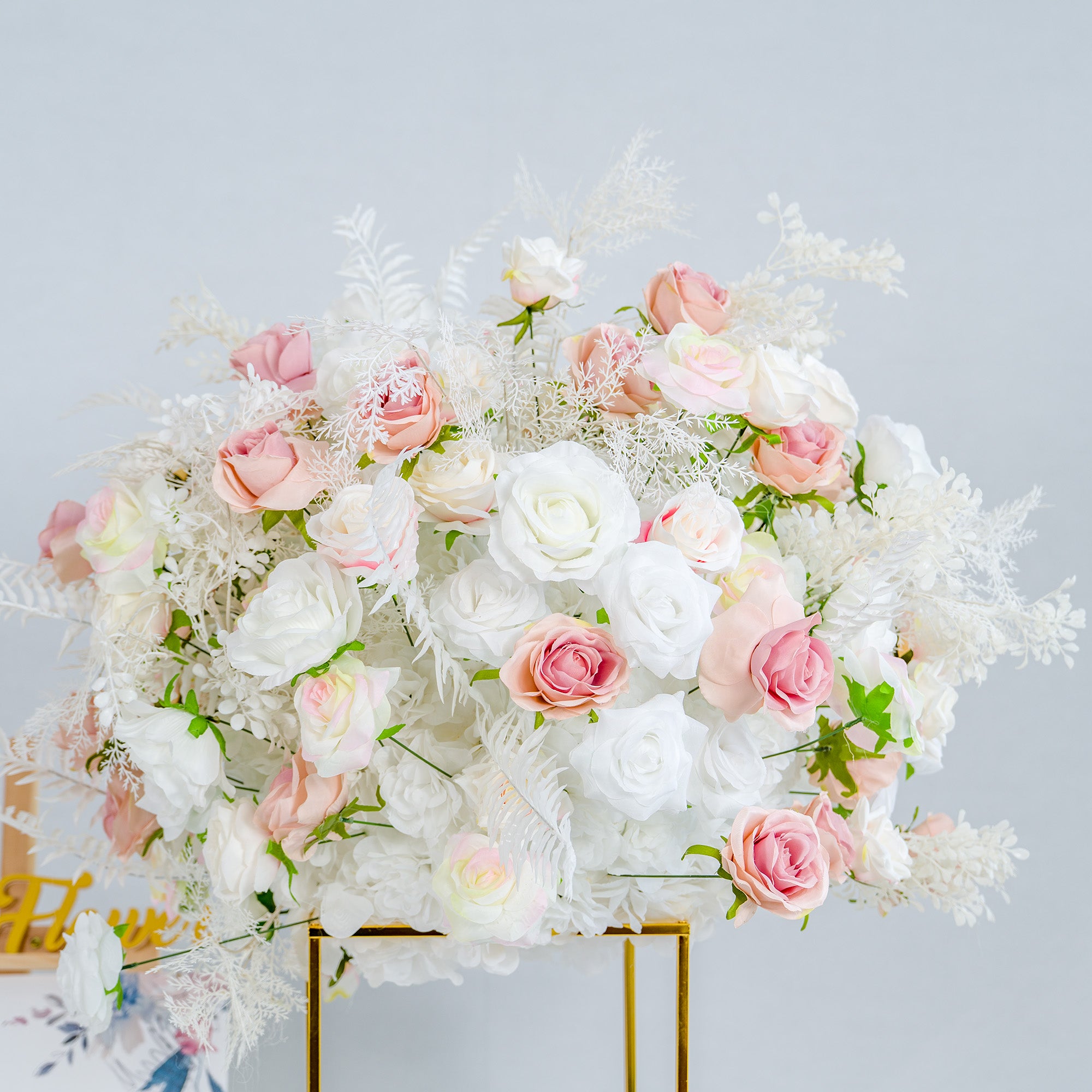 This photo showcases a sumptuous floral arrangement, ideal for weddings or high - end events. It combines white and pink roses, along with delicate white foliage, all set in a golden - framed stand. The soft pastel hues create an elegant and romantic atmosphere. Perfect for event decor, this display exudes sophistication and charm.