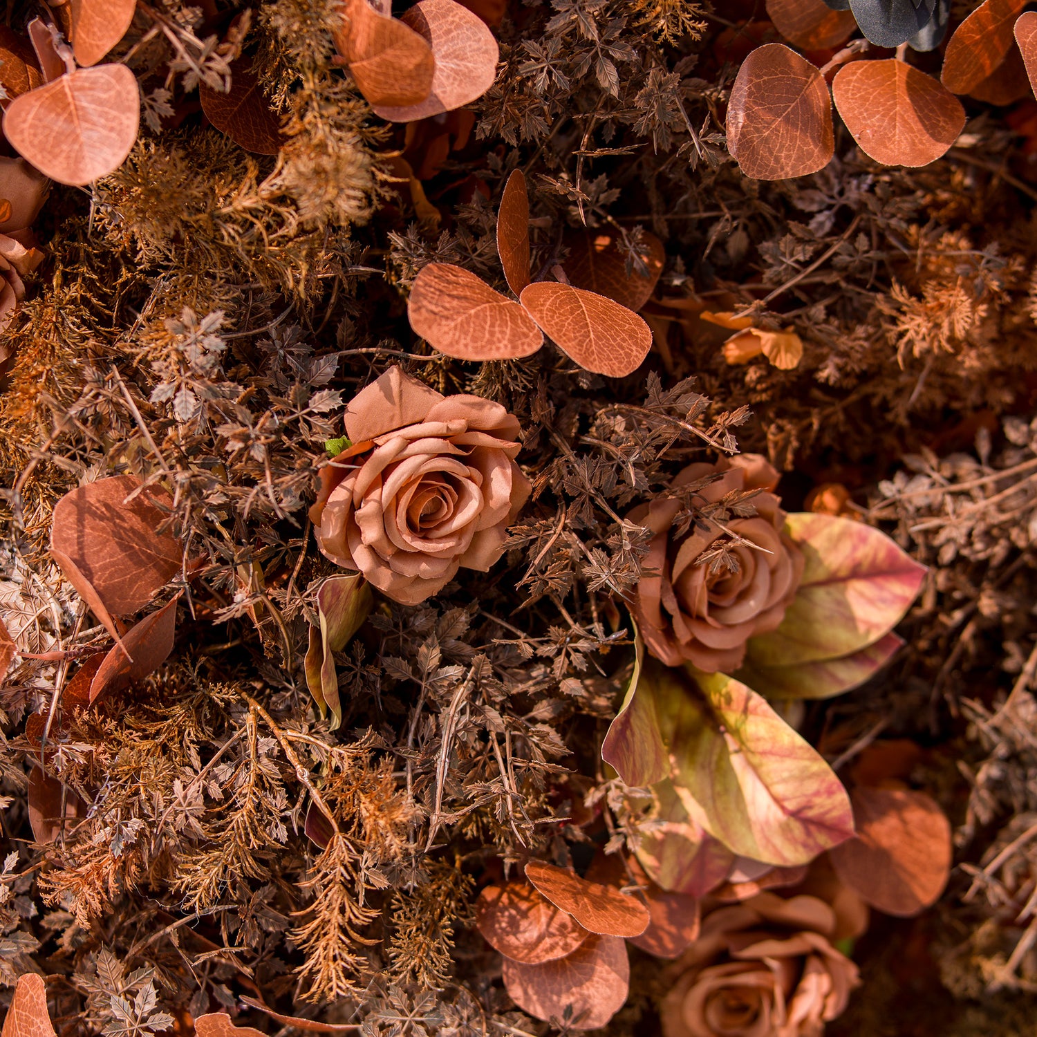 This photo showcases a lush arrangement of autumn - hued roses and various foliage in rich brown, rust, and copper tones. The blooms and leaves create a warm, textured display. Ideal for events like an “Autumn Elegance” wedding or a harvest - themed party, it exudes rustic charm, perfect for seasonal celebrations.