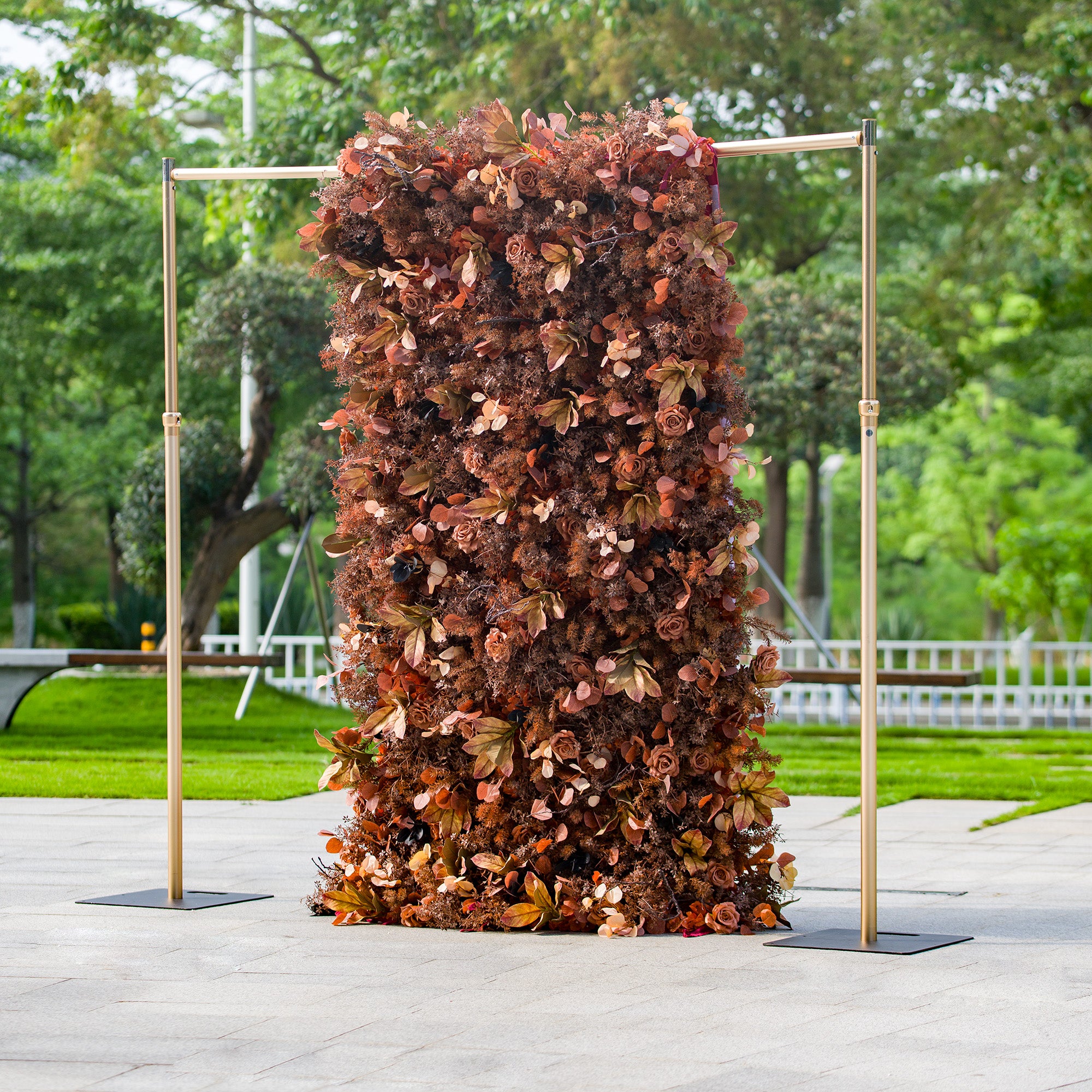 This 1.2x2.4m floral backdrop is a stunning display of autumnal - themed decor. It is densely packed with artificial roses and various foliage in warm shades of rust, brown, and copper. Set against an outdoor park - like backdrop, it exudes rustic elegance. Ideal for events such as an “Autumn Serenade” wedding or a fall - inspired corporate event, it creates a cozy, seasonal atmosphere.
