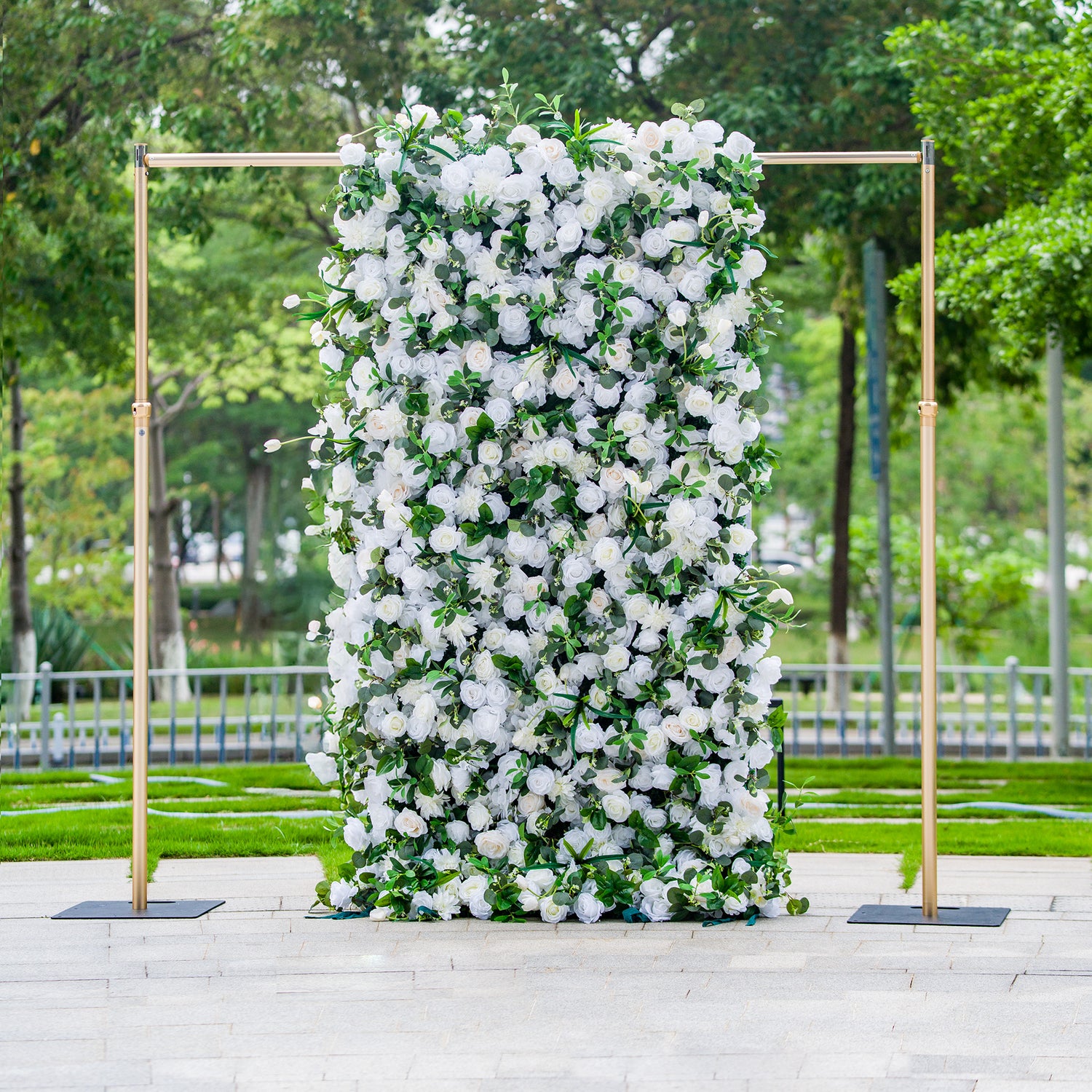This 4*8ft floral backdrop is densely adorned with white roses and other white blooms, interspersed with lush green foliage. Set outdoors with greenery in the background, it exudes elegance. Ideal for events like a “Celestial White” wedding or a refined garden party, it creates a sophisticated and serene atmosphere.