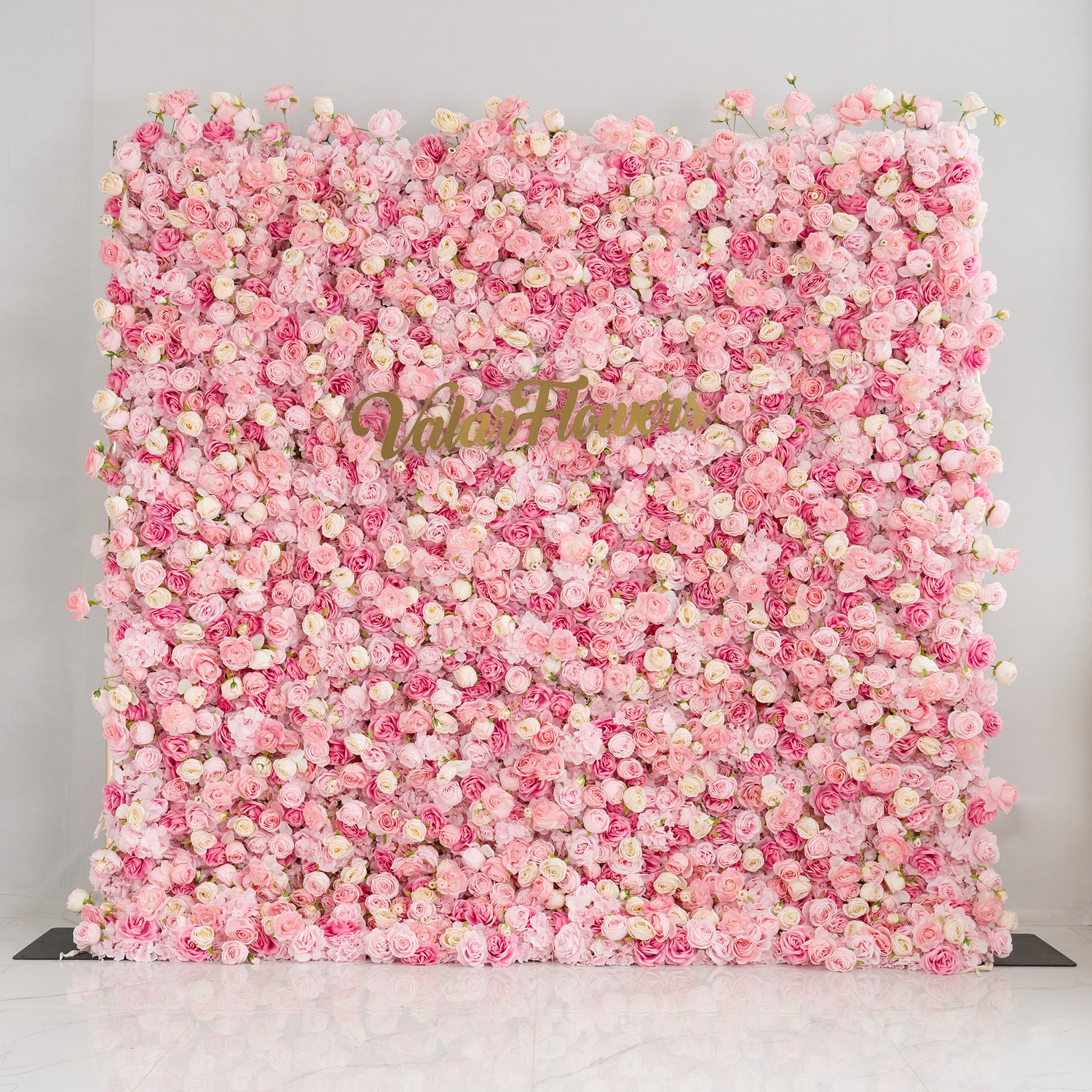This photo from ValarFlowers showcases a large, eye - catching floral backdrop. It is densely covered with Royal Roses in various shades of pink and white. These roses create a soft, romantic atmosphere. The backdrop is perfect for weddings, bridal showers, or other romantic events. The "ValarFlowers" logo is prominently displayed, signifying the brand&