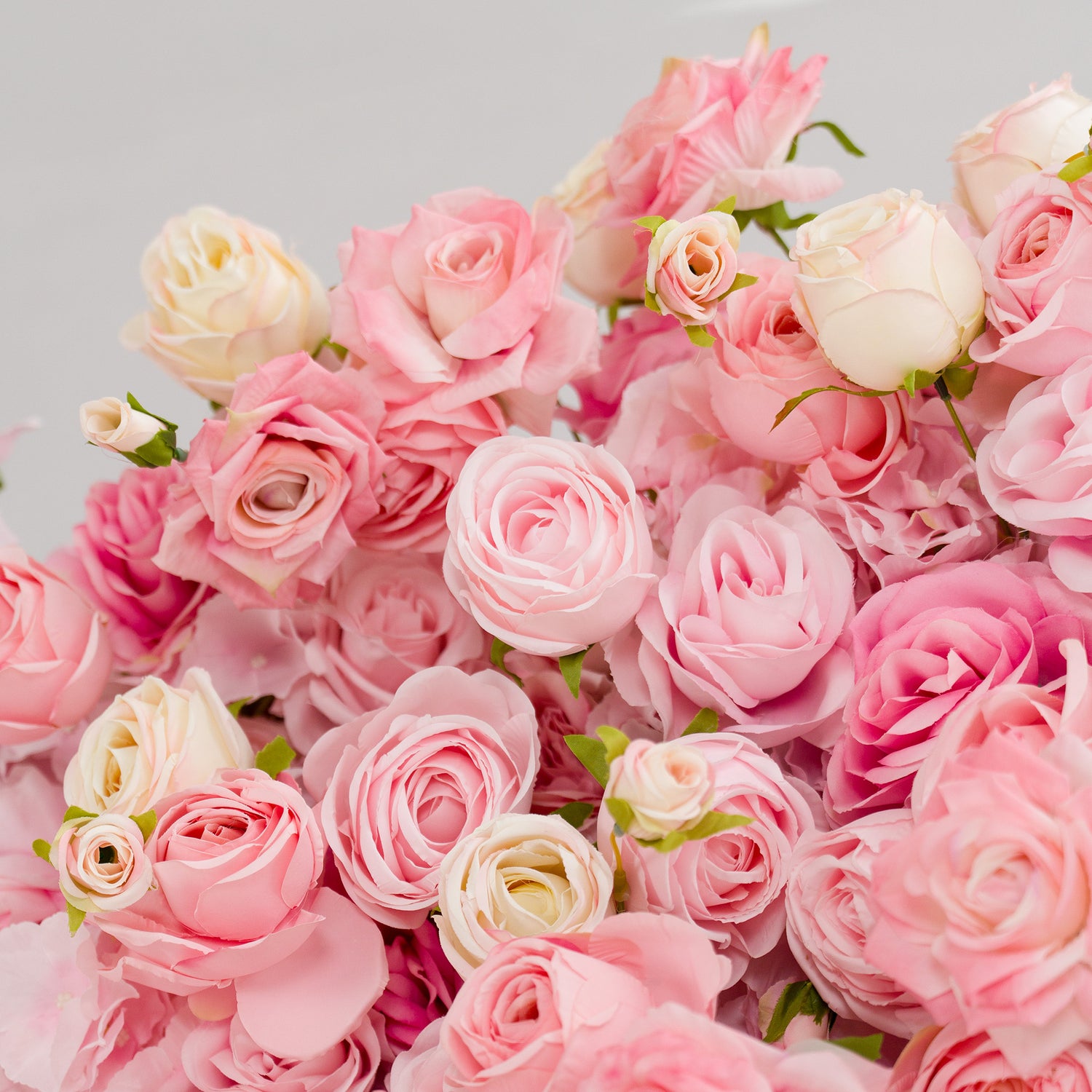 This photo from ValarFlowers showcases a lush arrangement of roses in soft pink and creamy white hues. The delicate petals and green foliage create an elegant and romantic display. Ideal for events such as weddings, bridal showers, and anniversaries, these roses exude charm and sophistication. ValarFlowers&