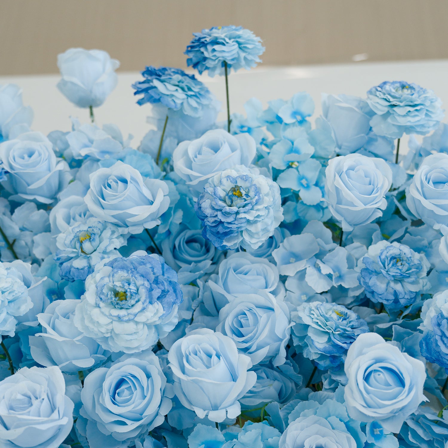 This photo showcases a lush arrangement of artificial light - blue roses and peony - like blooms. The monochromatic color theme, featuring soft and deeper shades of blue, creates a serene, elegant vibe. Ideal for events such as weddings, baby showers, or upscale parties, it offers a cohesive, tranquil aesthetic. The uniform hue and realistic textures of the faux flowers provide a polished, long - lasting decorative display, perfect for setting a sophisticated mood.