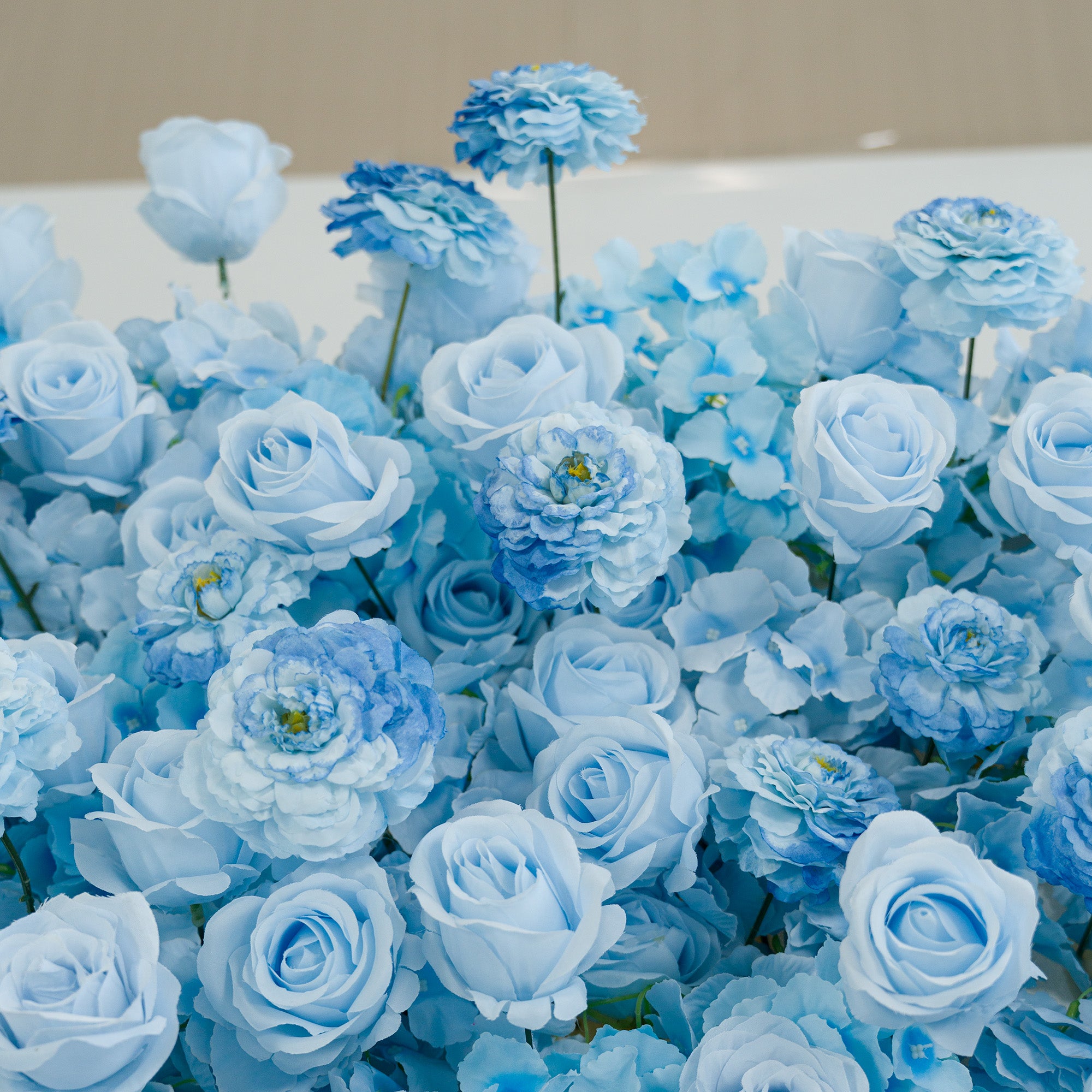 This photo showcases a lush arrangement of artificial light - blue roses and peony - like blooms. The monochromatic color theme, featuring soft and deeper shades of blue, creates a serene, elegant vibe. Ideal for events such as weddings, baby showers, or upscale parties, it offers a cohesive, tranquil aesthetic. The uniform hue and realistic textures of the faux flowers provide a polished, long - lasting decorative display, perfect for setting a sophisticated mood.