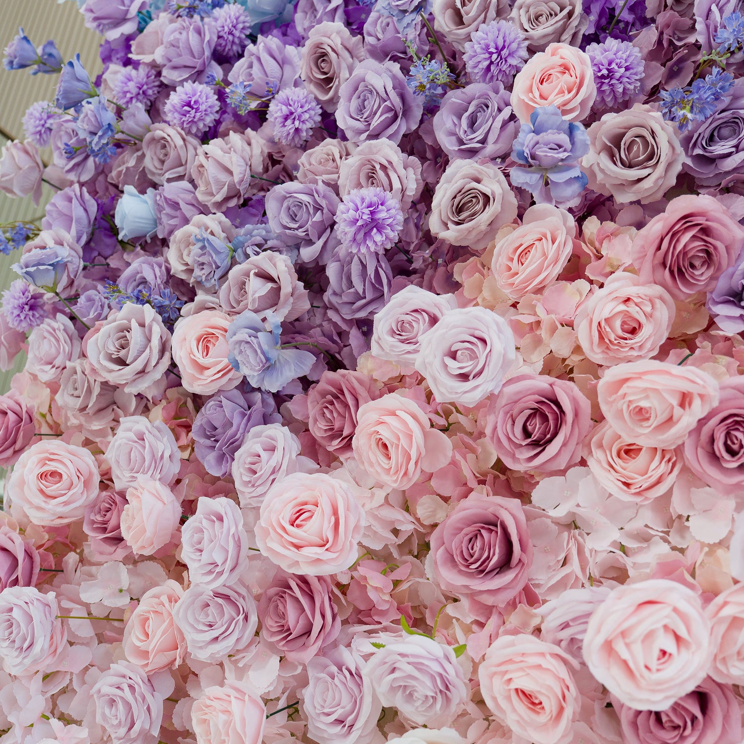 This photo features a lush floral wall with roses, chrysanthemums, and delphinium - like blooms. The color theme transitions from soft pink to lavender and purple, creating a dreamy, romantic vibe. Perfect for weddings, bridal showers, or upscale events, the pastel hues blend to form an elegant, photo - worthy backdrop. The varied flower types add texture, enhancing the sophisticated aesthetic ideal for memorable celebrations.