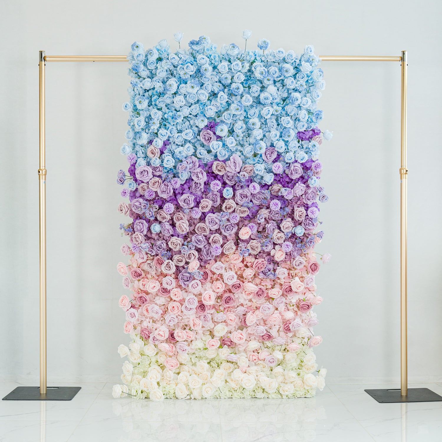 This stunning floral backdrop features a gradient of roses in hues of blue, purple, pink, and white. The ombre color theme, transitioning smoothly from sky - blue at the top to soft white at the base, creates a dreamy, elegant vibe. Framed by gold poles, it’s perfect for weddings, galas, or upscale events, serving as a sophisticated, photo - worthy centerpiece that blends natural beauty with polished design.