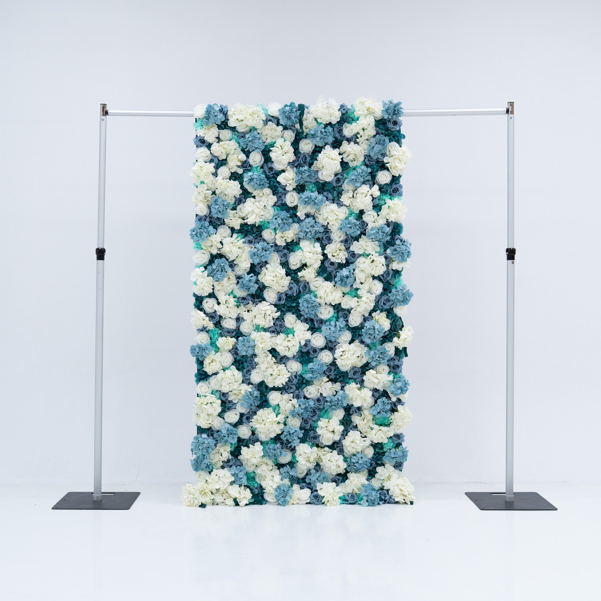 This 4x8ft flower wall from Valar Flowers is a stunning display of artificial roses in white and various shades of blue. The dense arrangement creates a visually appealing and vibrant backdrop, perfect for weddings, photo shoots, or other special events with a blue and white color theme. The meticulous arrangement of the roses enhances the overall aesthetic, adding a touch of sophistication and natural beauty to any setting.