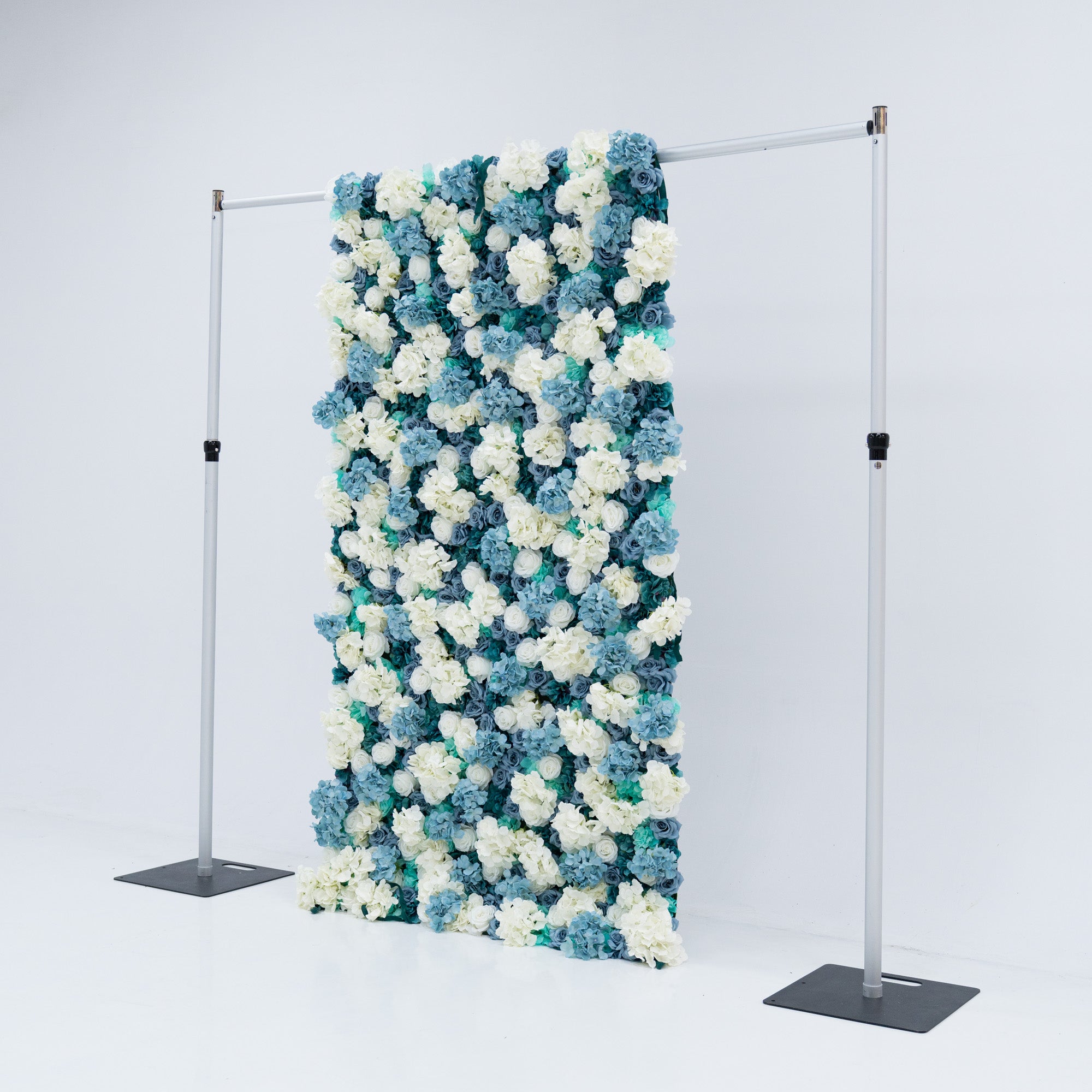 This 4x8ft flower wall from Valar Flowers is a stunning display of artificial roses in white and various shades of blue. The dense arrangement creates a visually appealing and vibrant backdrop, perfect for weddings, photo shoots, or other special events with a blue and white color theme.