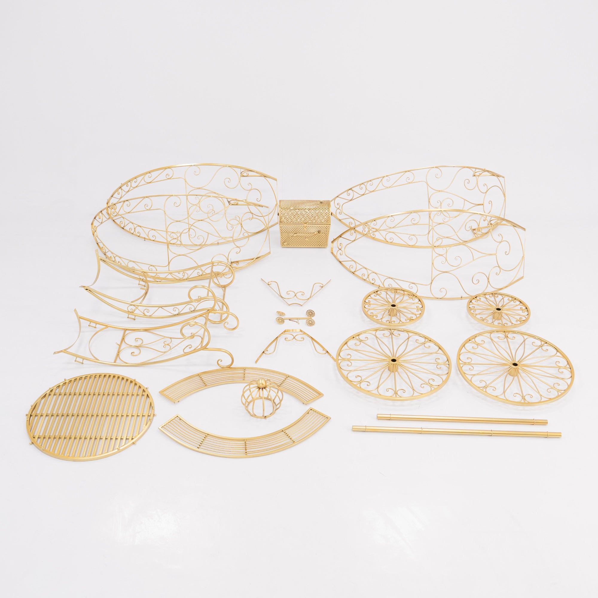 Unassembled parts of a golden, ornate Cinderella - style carriage. Features intricate wrought - iron scrollwork for the frame, wheels, and decorative elements, plus a latticework trunk. Perfect for building a fairy - tale - themed display, showcasing detailed craftsmanship.
