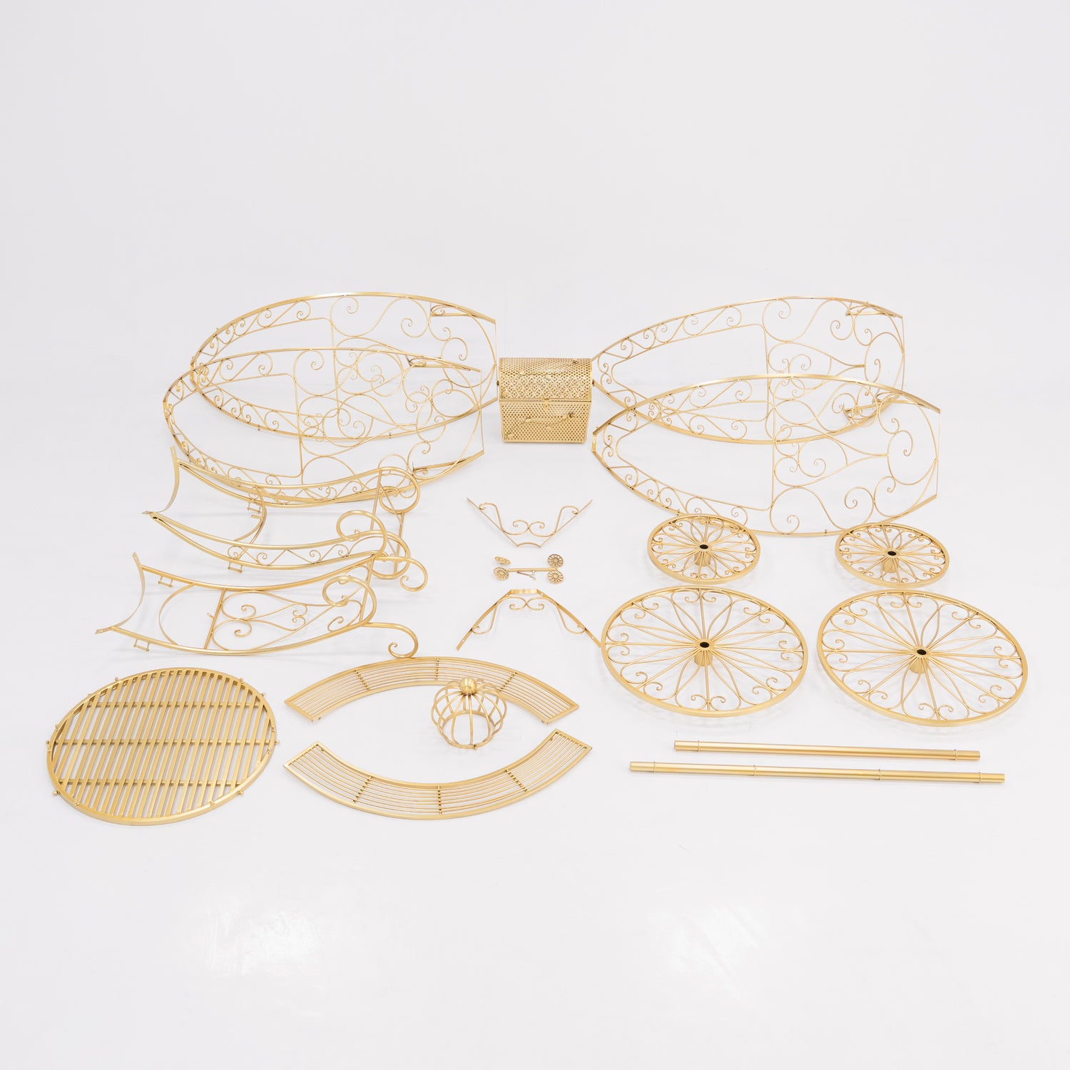 Unassembled parts of a golden, ornate Cinderella - style carriage. Features intricate wrought - iron scrollwork for the frame, wheels, and decorative elements, plus a latticework trunk. Perfect for building a fairy - tale - themed display, showcasing detailed craftsmanship.