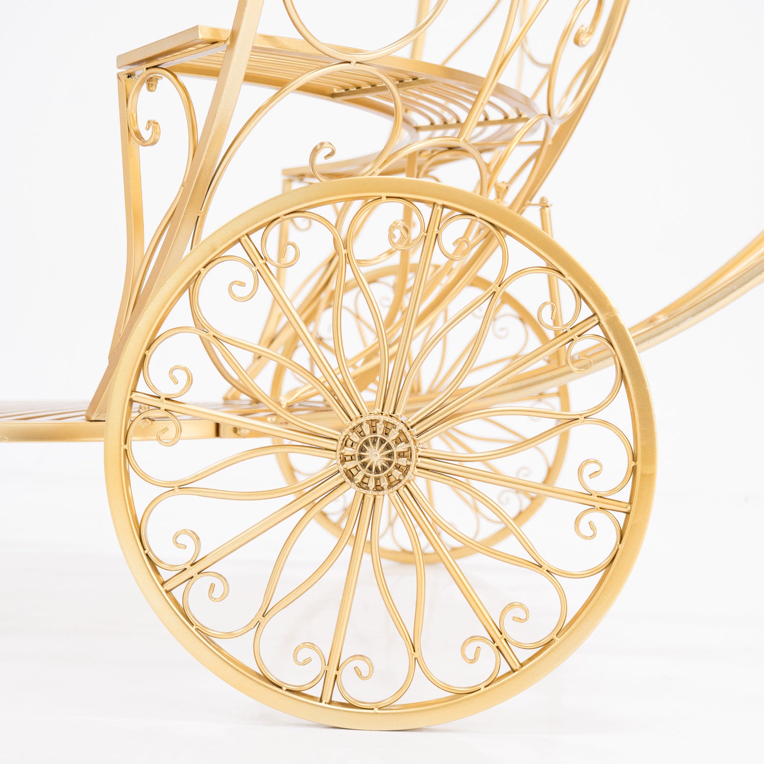 A close - up of a golden, ornate wheel from a Cinderella - style carriage. Intricate scrollwork and a decorative hub showcase elaborate wrought - iron design. The shimmering gold finish adds fairy - tale charm, perfect for themed displays.