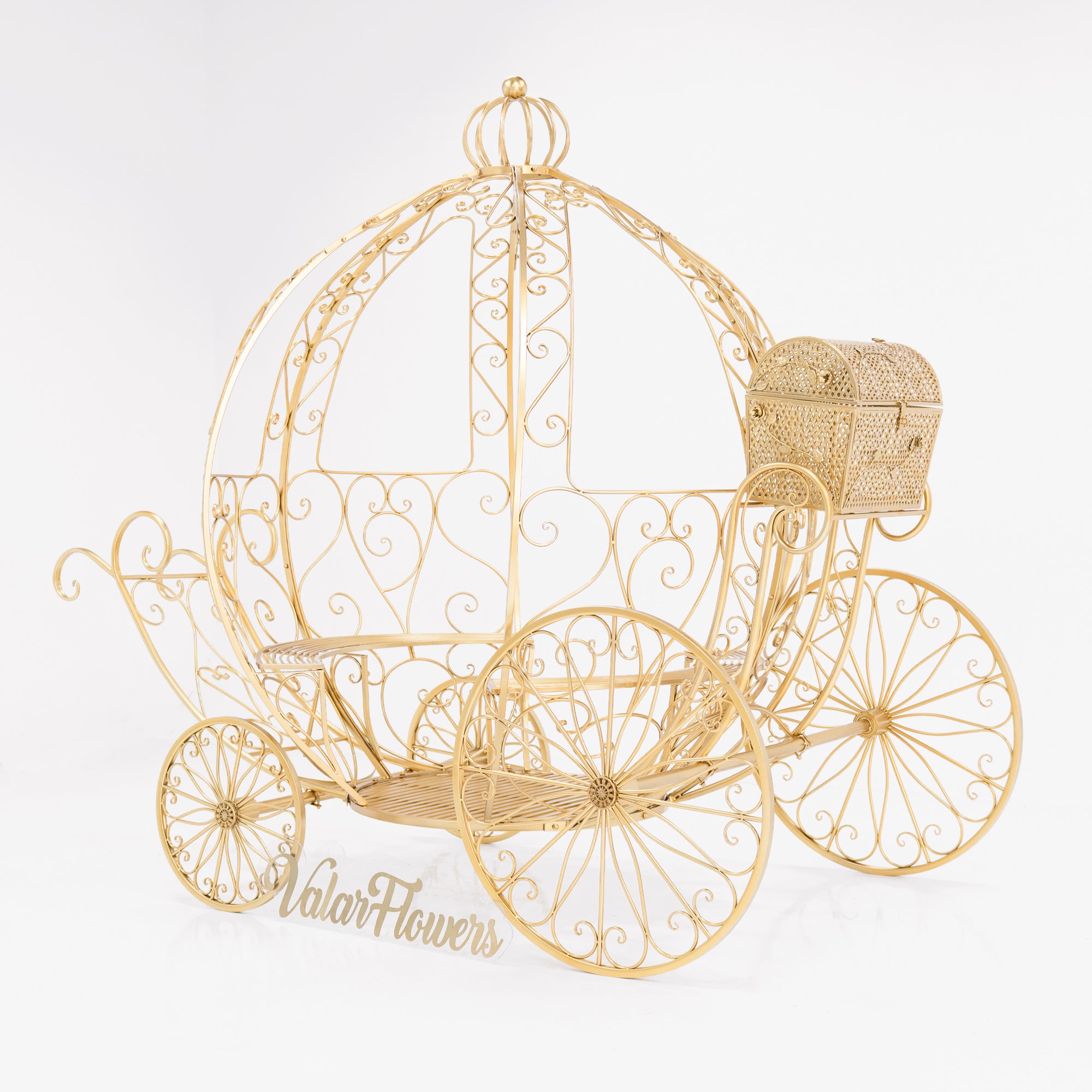 A life - size, gold - toned Cinderella - style carriage with intricate wrought - iron scrollwork. Features a curved, open - air design, large decorative wheels, and a small attached latticework trunk. “ValarFlowers” branding adds a touch, perfect for fairy - tale - themed events.