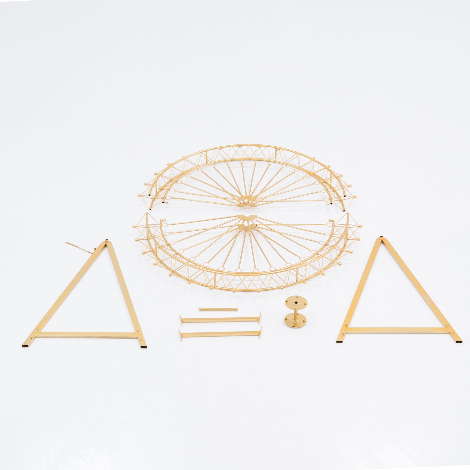 Unassembled parts of a golden Ferris wheel decoration. Includes a circular frame with spokes, two triangular stands, and small metal components. Designed for easy assembly, perfect for decorative, themed event setups.