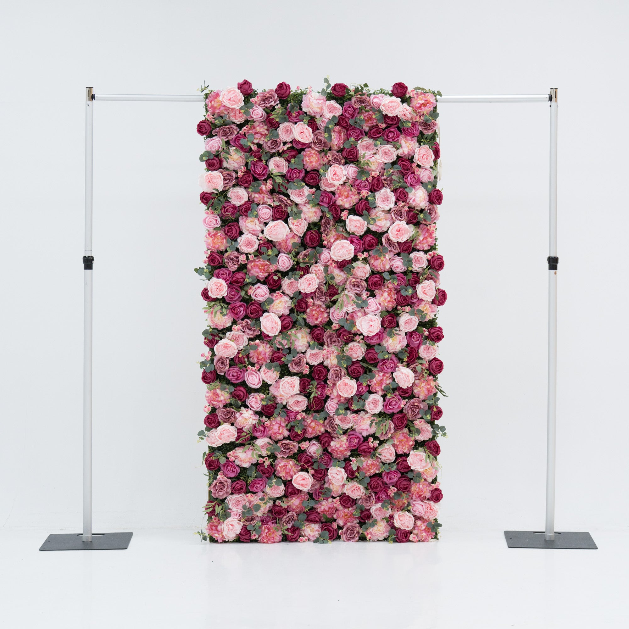 A 4x8ft artificial flower wall features a dense, vibrant arrangement of pink and deep - pink roses, interspersed with green foliage. Mounted on a metal frame, it creates an elegant, romantic backdrop—ideal for events, exuding charm and sophistication with its lush, colorful blooms.