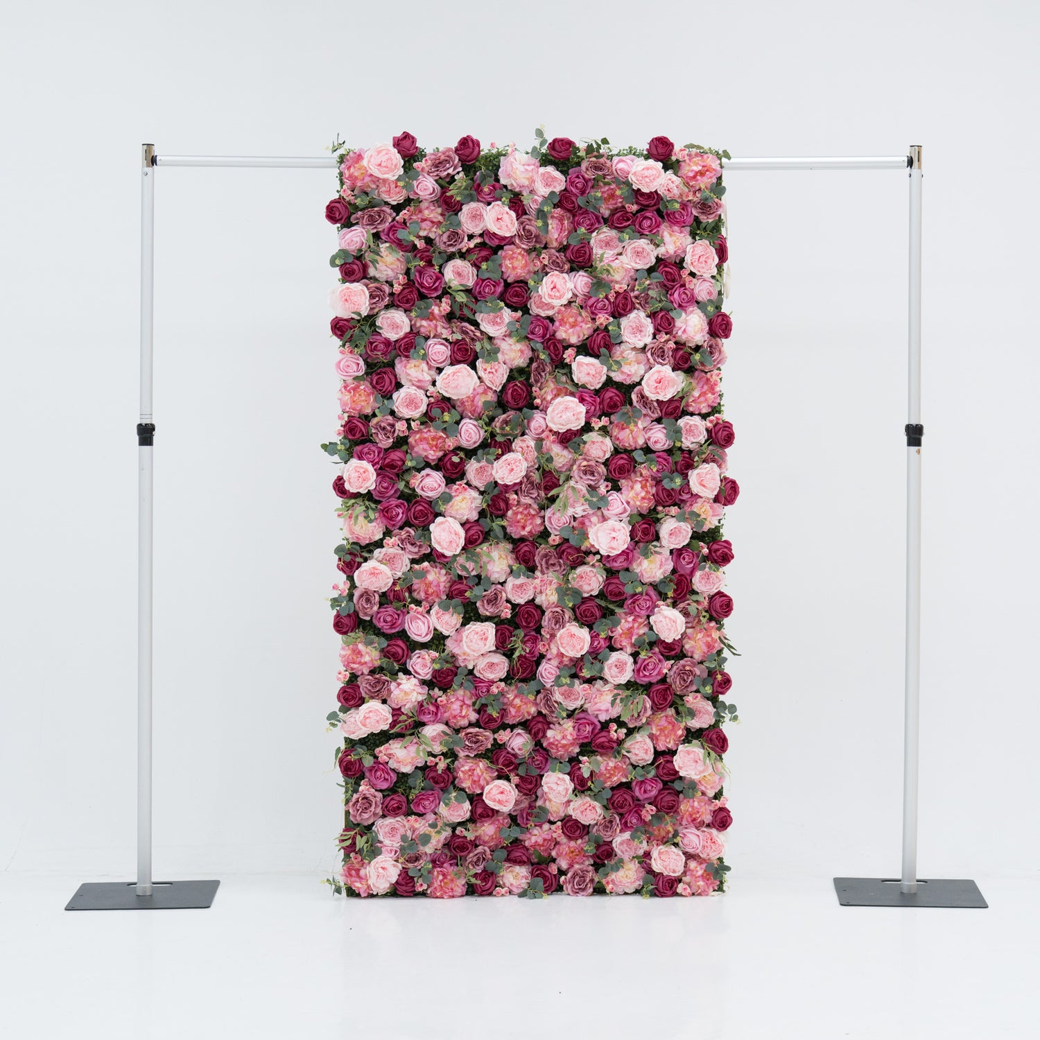 A 4x8ft artificial flower wall features a dense, vibrant arrangement of pink and deep - pink roses, interspersed with green foliage. Mounted on a metal frame, it creates an elegant, romantic backdrop—ideal for events, exuding charm and sophistication with its lush, colorful blooms.