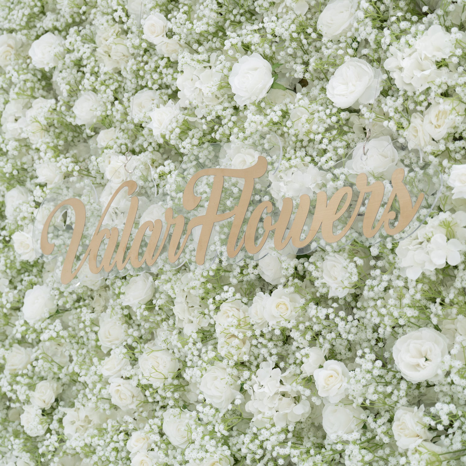 This image showcases a stunning floral wall by Valar Flowers, densely adorned with white roses and baby&