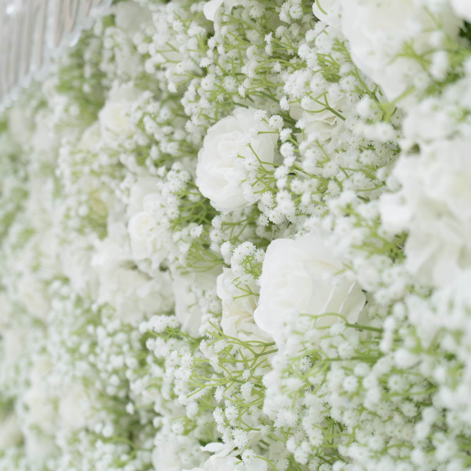 This image features a lush arrangement of white flowers, including roses and baby&