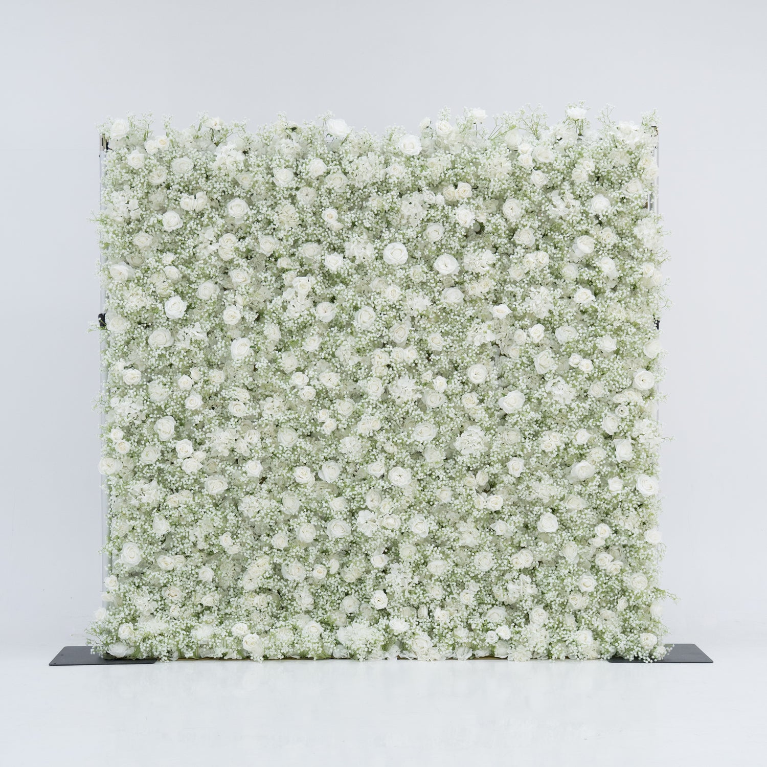 This image features a large, square floral wall densely covered with white flowers, including baby&