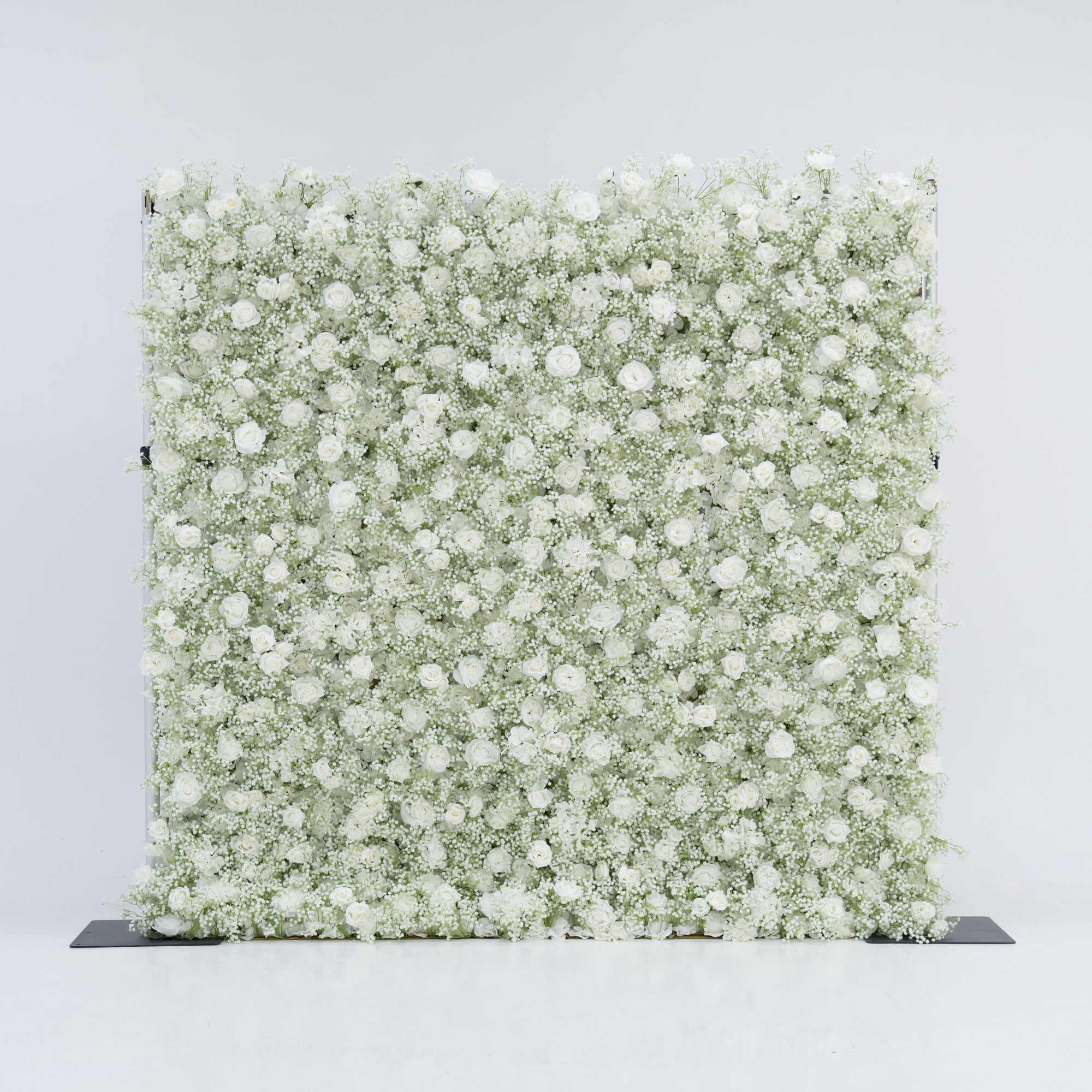 This image features a large, square floral wall densely covered with white flowers, including baby&