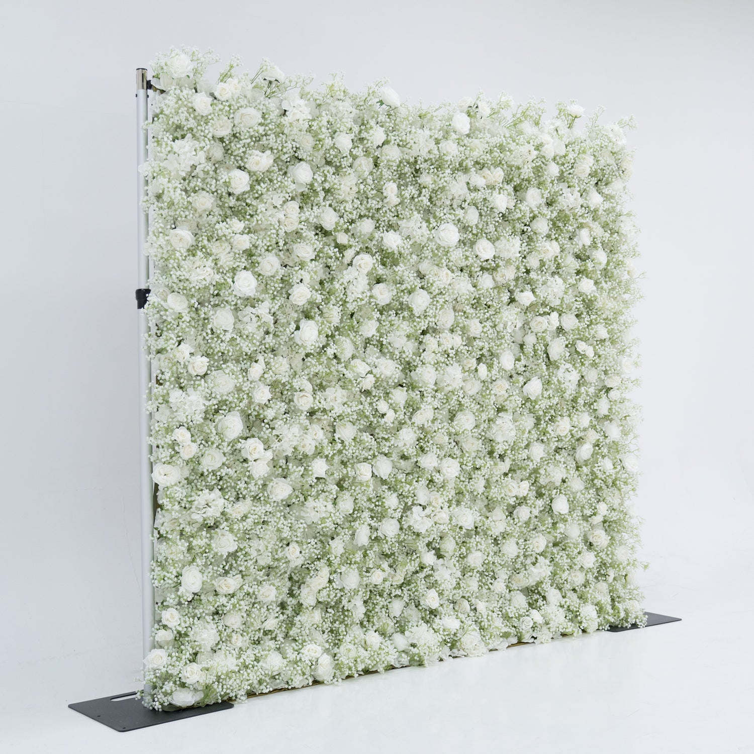 This image displays an 8x8ft floral wall by Valar Flowers, densely covered with white roses and baby&