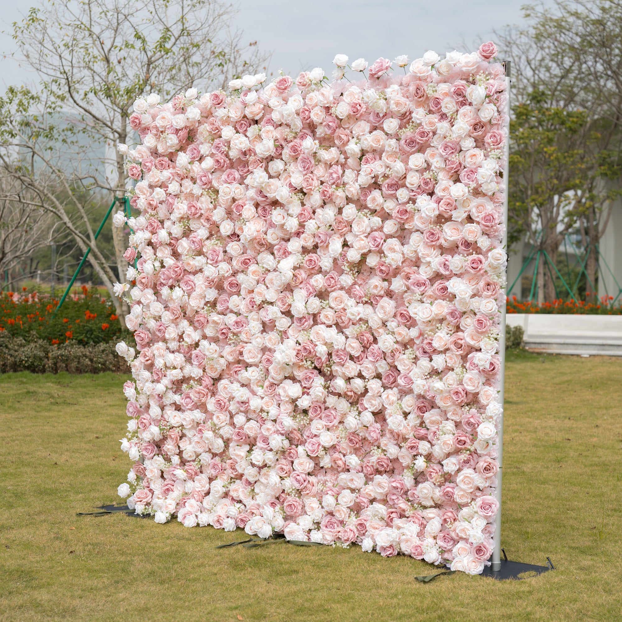 This premium blush pink and white artificial flower wall by Valar Flowers features a lush, gradient arrangement of roses and peonies. The dense, layered design creates a romantic, timeless aesthetic, ideal for weddings, photo booths, and luxury events. Maintenance-free and durable, this reusable backdrop offers a soft, elegant look perfect for professional styling, brand activations, and dreamy decor.