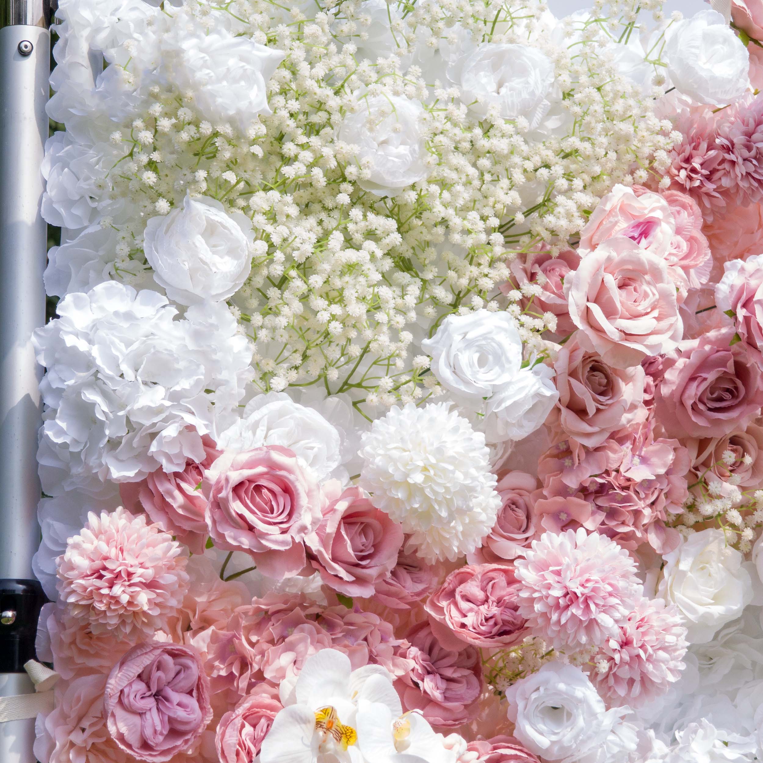 This backdrop features a lush arrangement of artificial flowers. Prominent flowers include white and pink roses, white hydrangeas, and clusters of baby&