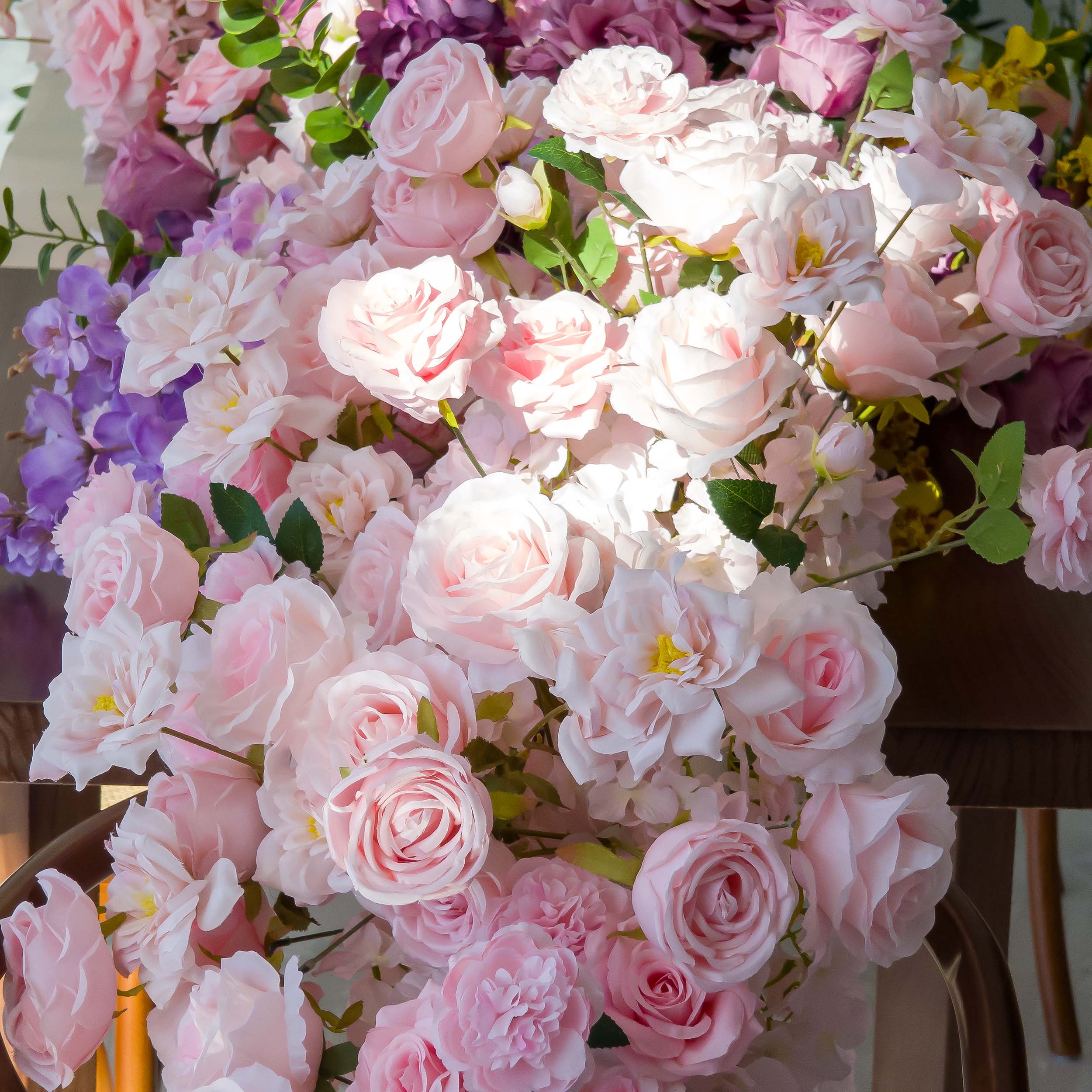 This close-up from Valar Flowers showcases a lush, romantic cluster of soft pink, blush, and lavender blooms—including roses, peonies, and delicate sprigs—interwoven with vibrant green foliage. The velvety petals and layered textures create a dreamy, sophisticated atmosphere, ideal for weddings, engagement shoots, or elegant celebrations.