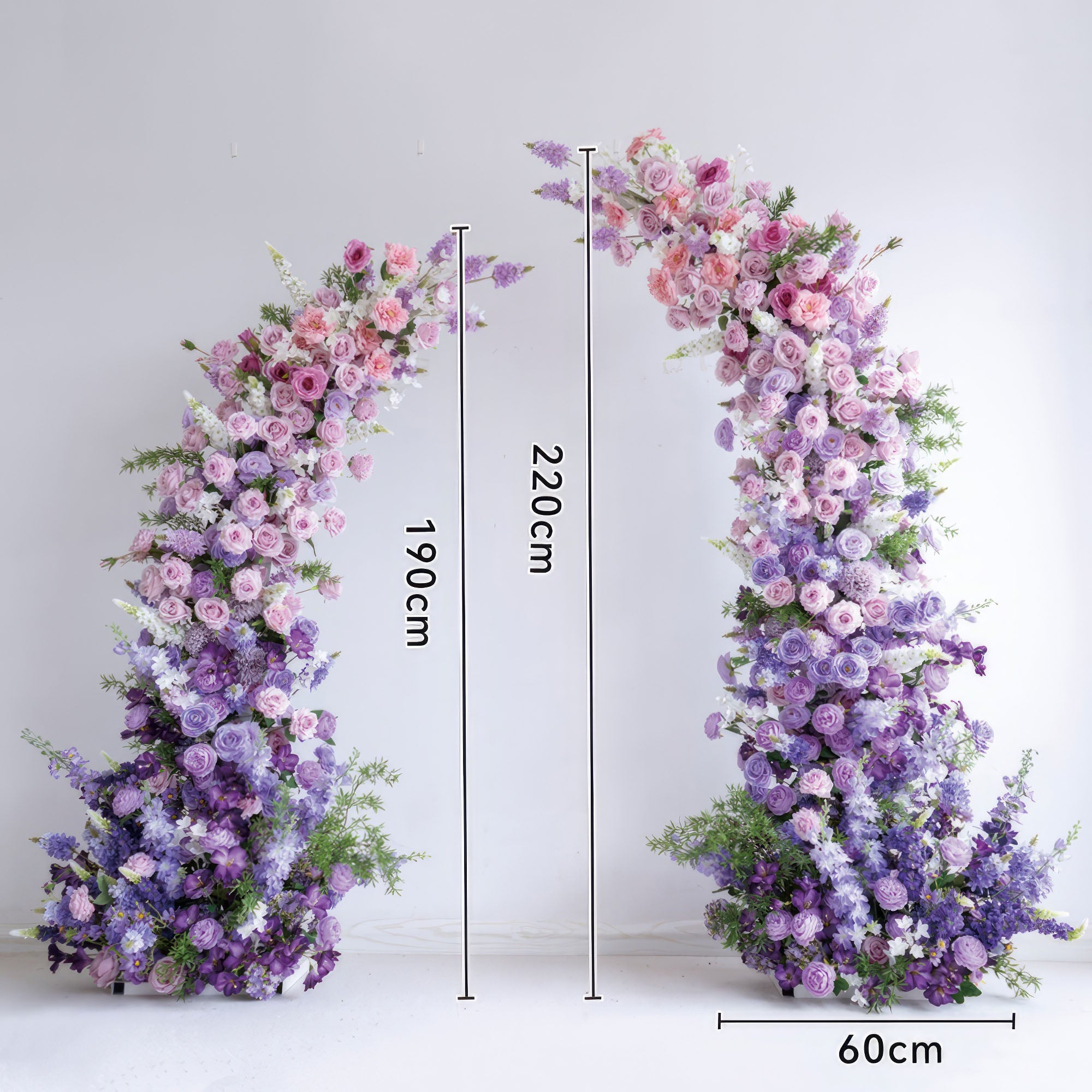 This elegant floral arch from Valar Flowers features a soft gradient of blush pink, lavender, and deep purple blooms—including roses, ranunculus, and hydrangeas—arranged in two cascading columns. Standing 220cm tall, it evokes a romantic, sophisticated atmosphere ideal for weddings, engagement photoshoots, or elegant celebrations.