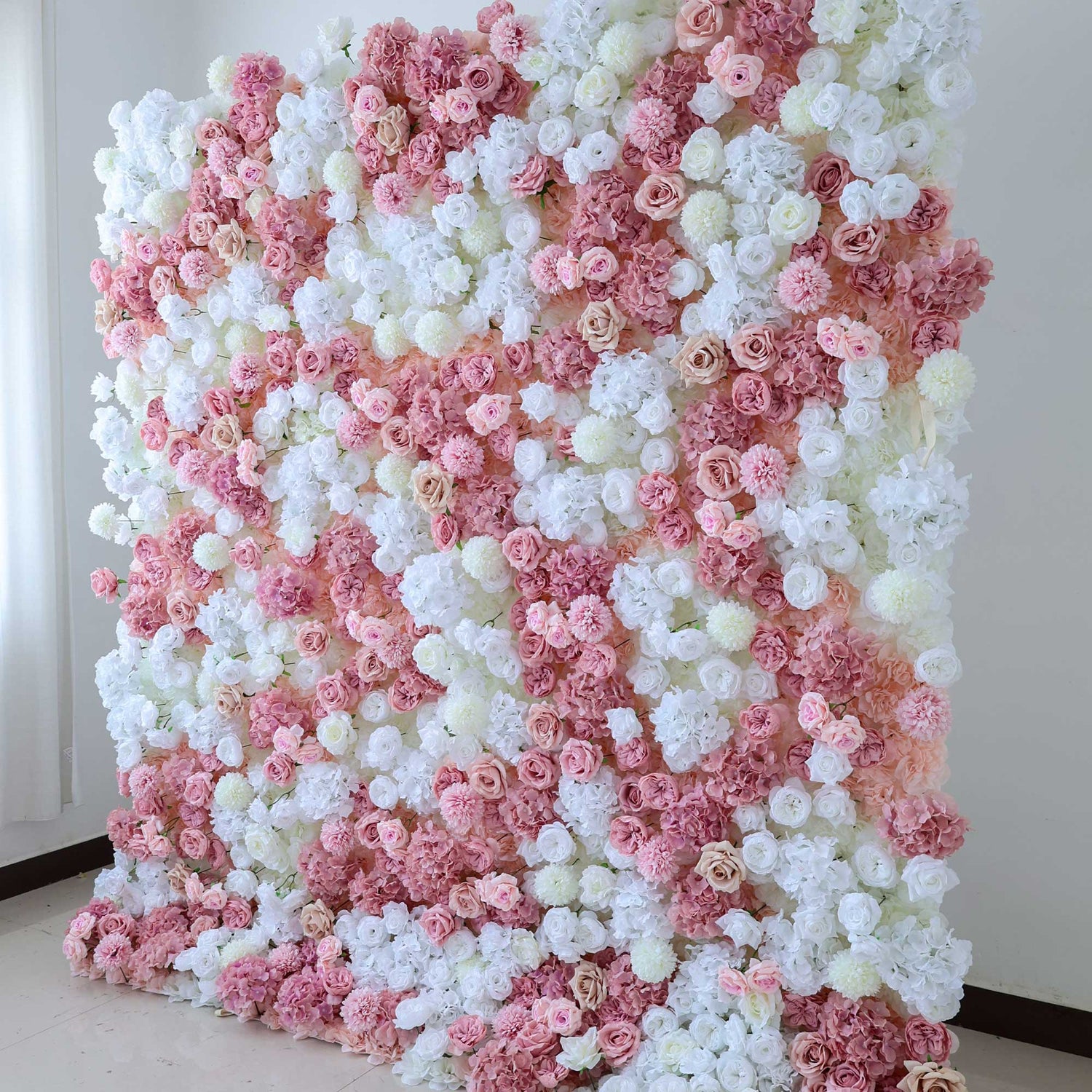 This floral wall showcases an array of white and pink roses, hydrangeas, and other blooms, creating a soft and romantic decorative display.