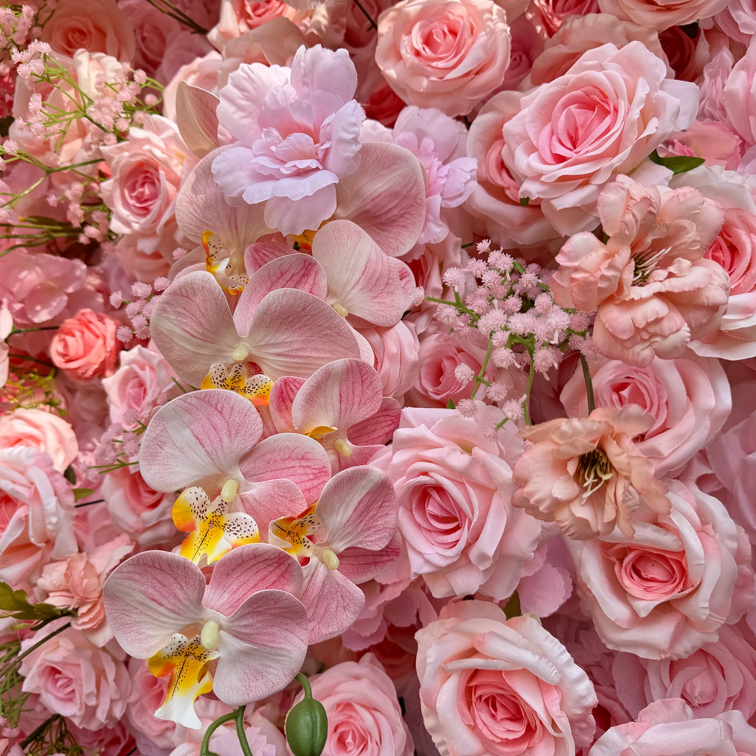 This photo features a lush arrangement of soft pink roses and delicate pink orchids, interspersed with small pink flowers. The pastel - colored blooms create a gentle and romantic atmosphere. Ideal for events like a "Blushing Elegance" bridal shower or a refined garden tea party, it combines the grace of roses and orchids, making it perfect for intimate and elegant occasions.