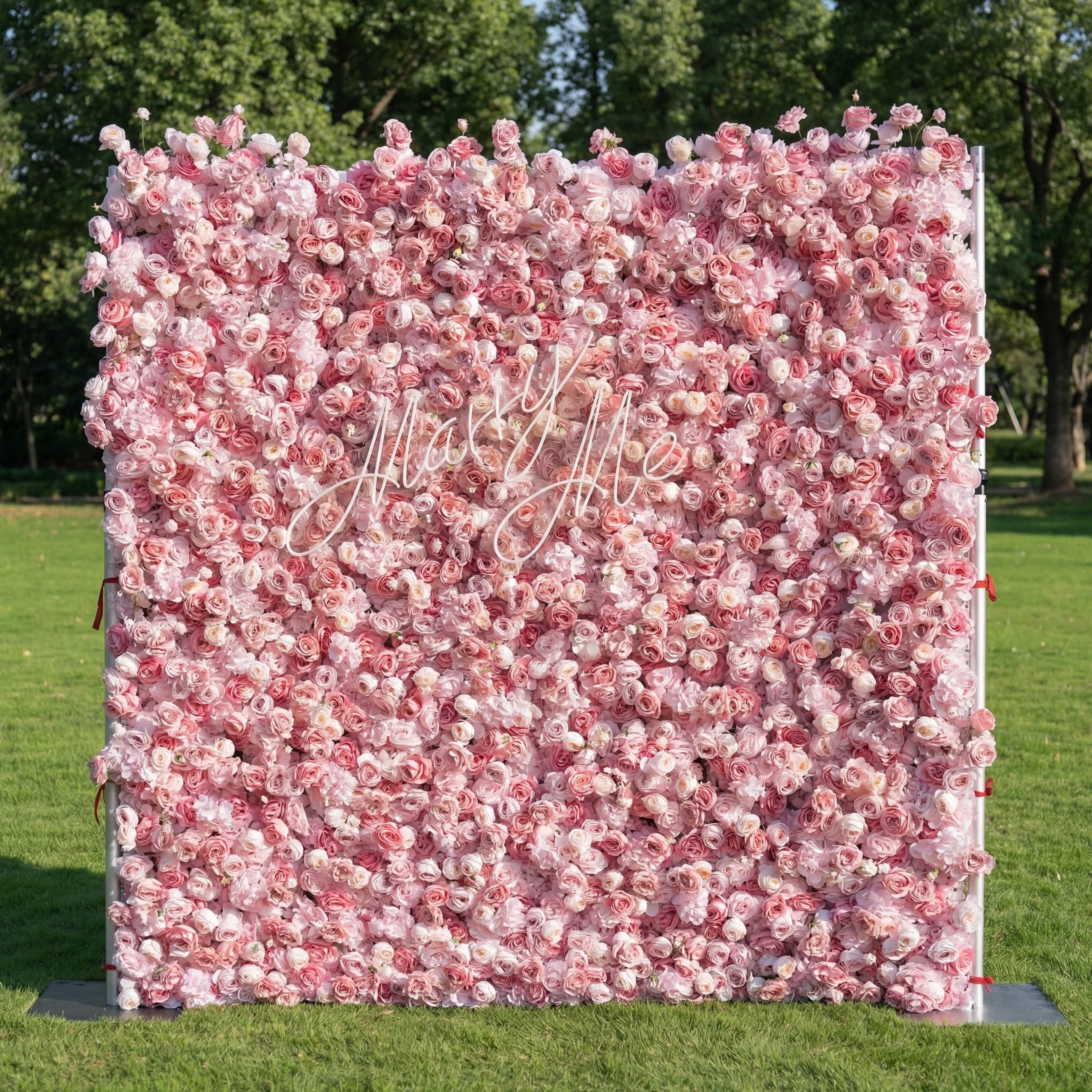 This outdoor backdrop (set on lush green grass, tree-framed) is a dense wall of soft pink and ivory roses. A delicate, cursive "Marry Me" sign nestles within the blooms, amplifying the dreamy, romantic vibe. The blush-toned, full floral display exudes timeless elegance—perfect for proposal setups, wedding decor, or intimate outdoor events.
