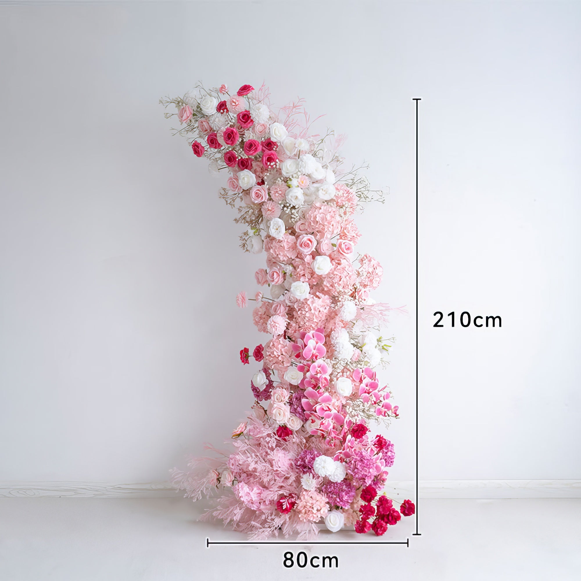 This 210cm tall, 80cm wide floral arrangement features a romantic, cascading gradient of soft pink, deep rose, and white blooms, including hydrangeas, roses, and delicate filler flowers. The lush, layered design creates a dreamy, three-dimensional texture, making it a stunning focal point for weddings, engagement photoshoots, or romantic celebrations against a minimalist white backdrop.